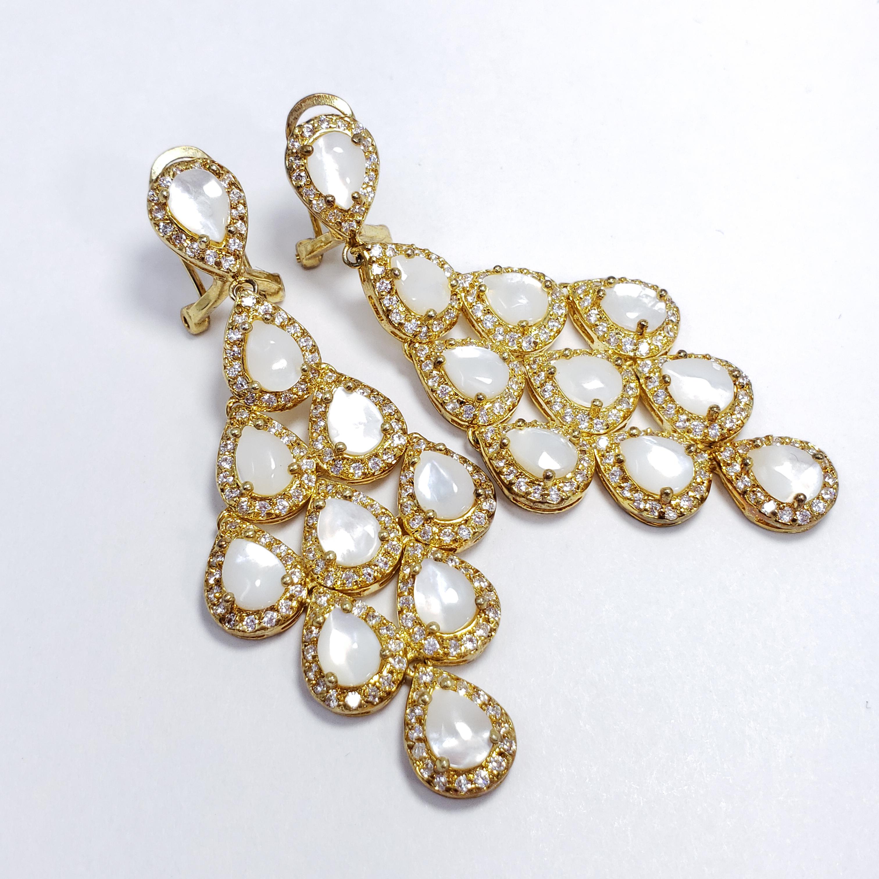 An exquisite pair of earrings by Kenneth Jay Lane! Each earring features a glittering and glamorous drop made up of teardrop-shaped opaque crystals and a pave crystal trim. Goldtone metal.

Finding: Post with Clip
Hallmarks: KJL
