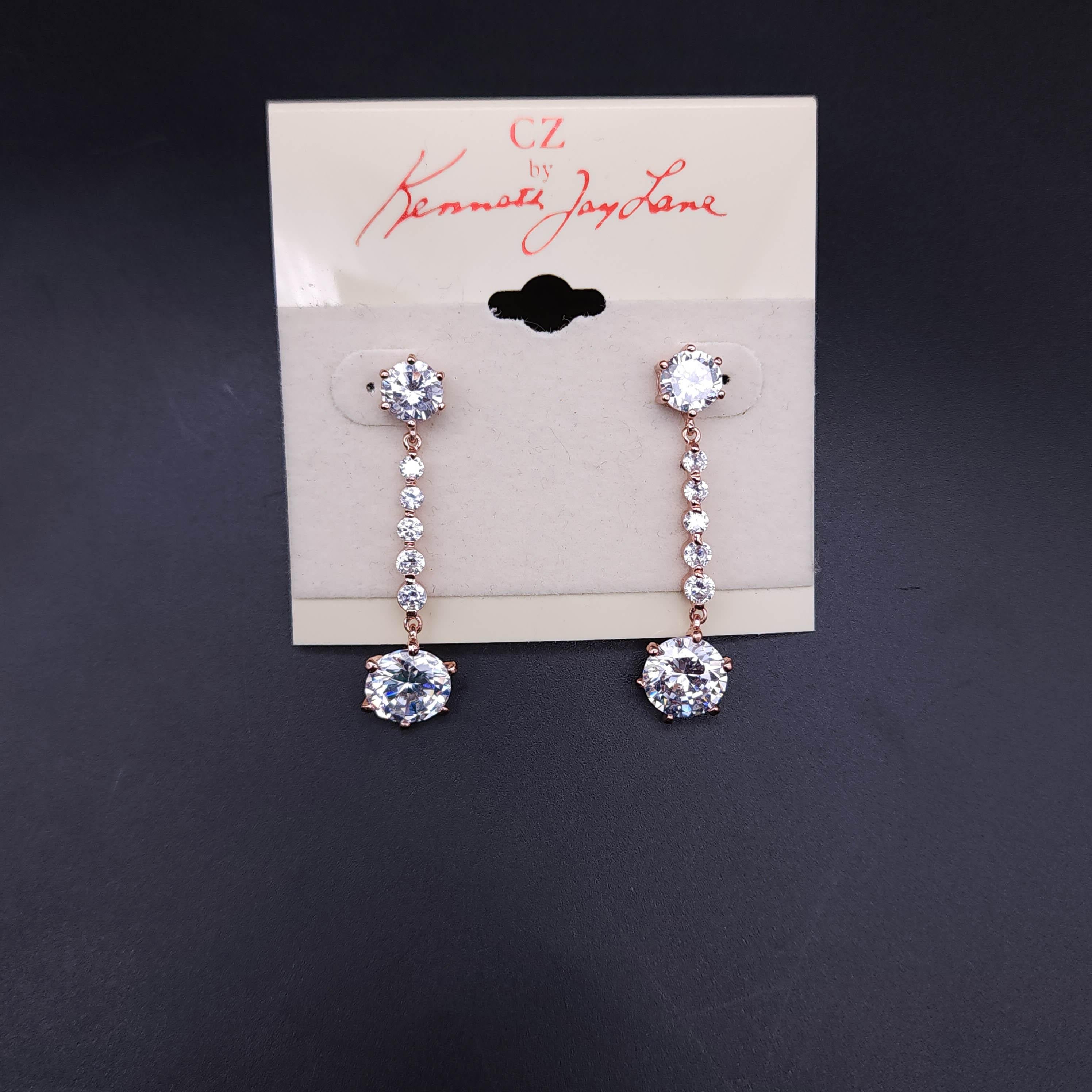 Illuminate your look with the CZ by Kenneth Jay Lane crystal dangle earrings. These stunning earrings feature prong-set cubic zirconia that glisten with a clear brilliance, complemented by the warm, blush hues of the rose gold tone. The dangle