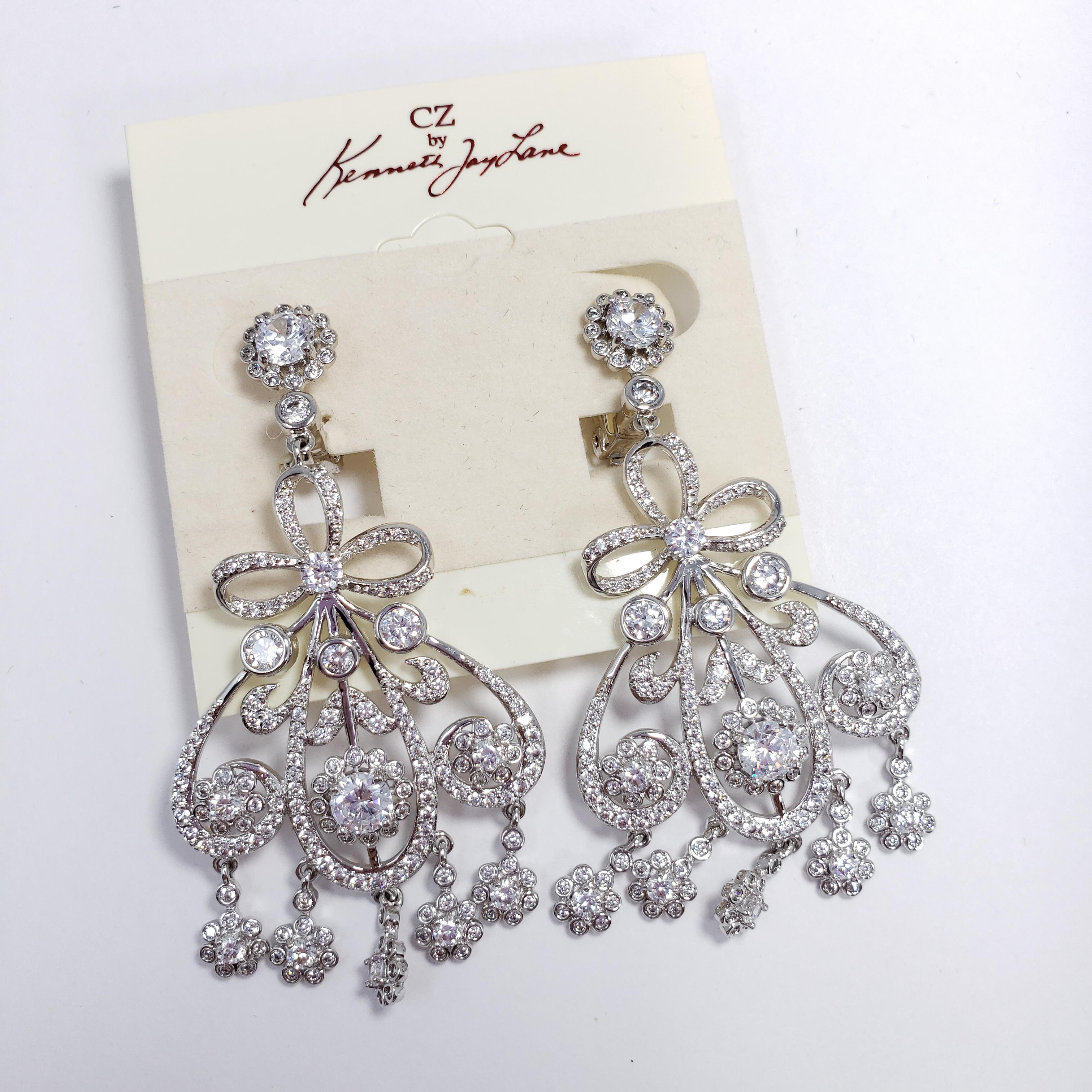 From Kenneth Jay Lane's Cubic Zirconia line. Exquisite art-nouveau inspired silver-tone motifs are accented with lustrous clear cubic zirconia crystals. Large and extravagant!

Hallmarks: KJL
CZ Cubic Zirconia line by Kenneth Jay Lane. Designer