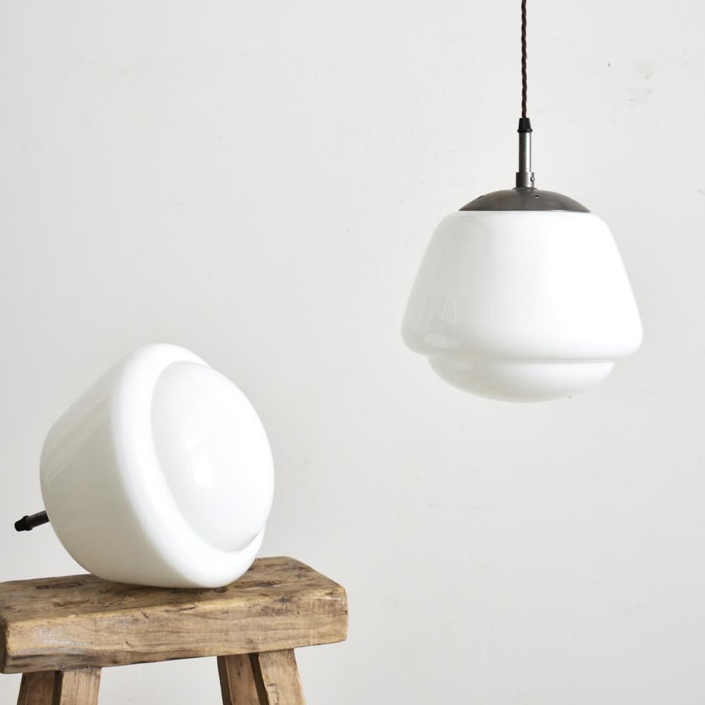 Czech Opaline pendant light – B.

A vintage opaline glass pendant light salvaged from a school in former Czechoslovakia, featuring a lovely moulded decorative shape. The glass which has a gloss finish provides a striking even glow when illuminated