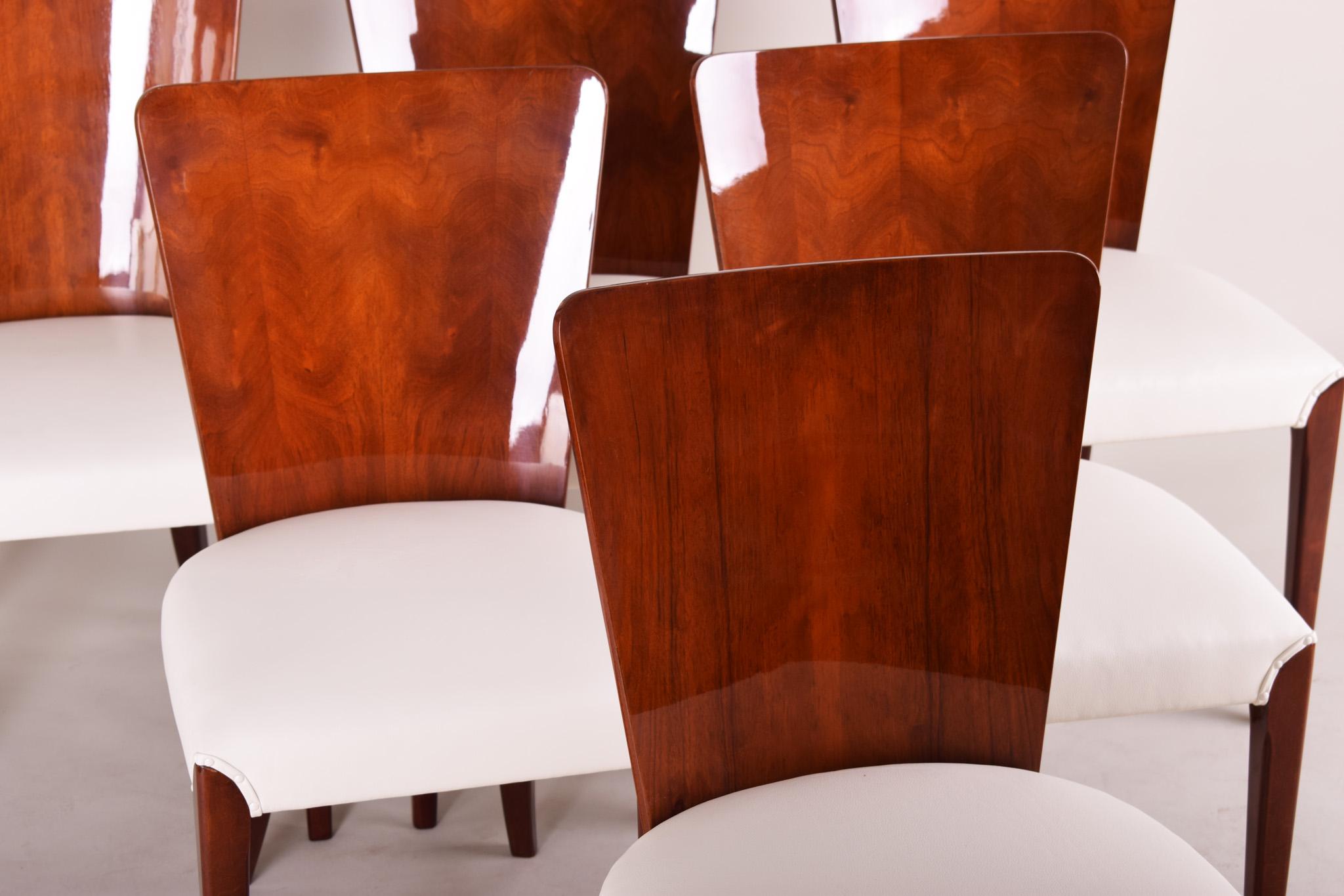 Czech Art Deco chairs, six pieces.
Material: Mahogany
Period: 1940-1949
Completely restored, surface made by piano lacquers to the high gloss. New upholstery.
Made by architect Jindrich Halabala in United Arts & Crafts manufacture in Brno.

We