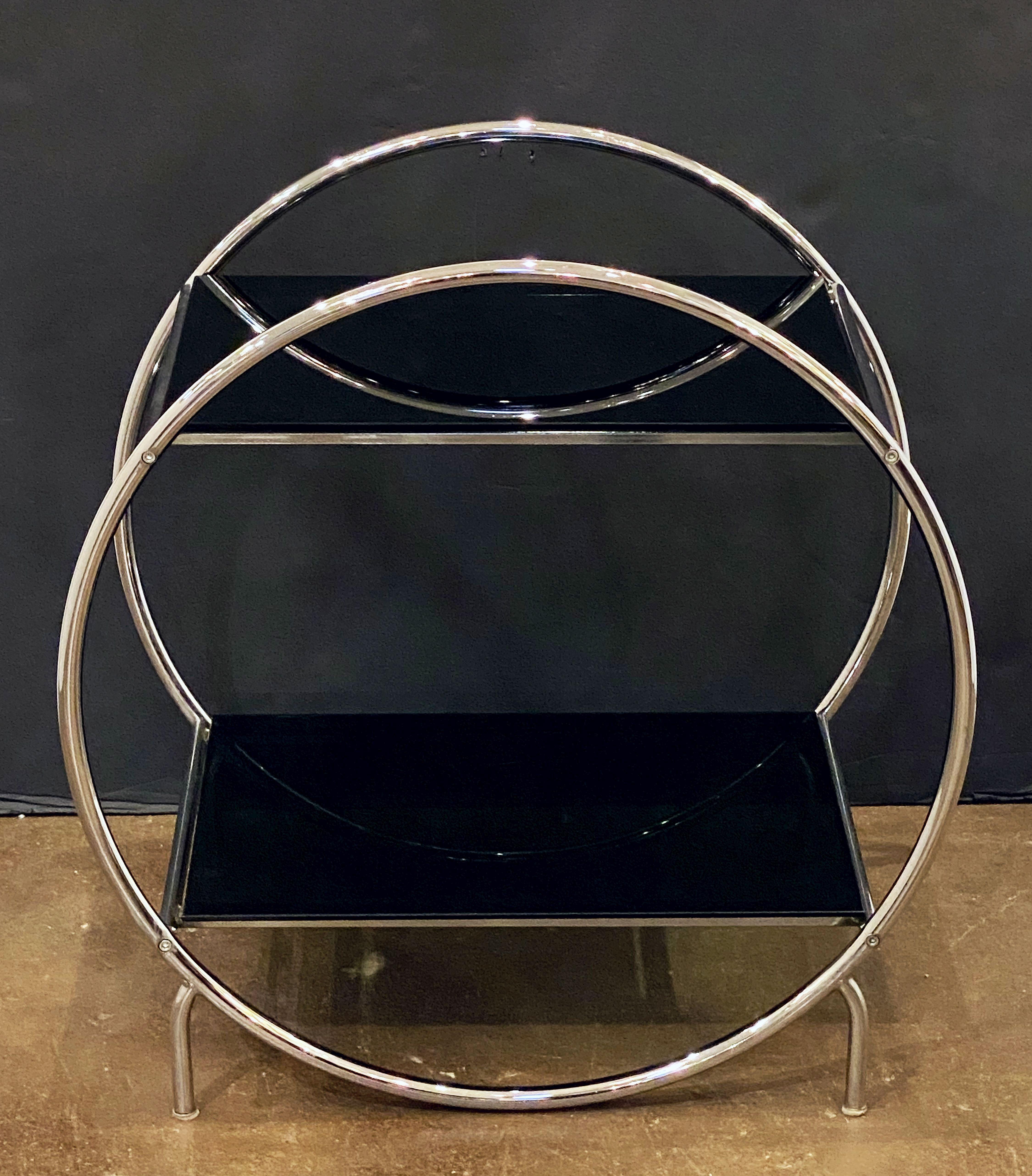 A fine Czech modernist table from the Art Deco period by the celebrated furniture producer, Slezákovy Závody, featuring two tiers of smoked black glass, set upon a stylish tubular chrome frame.



             
