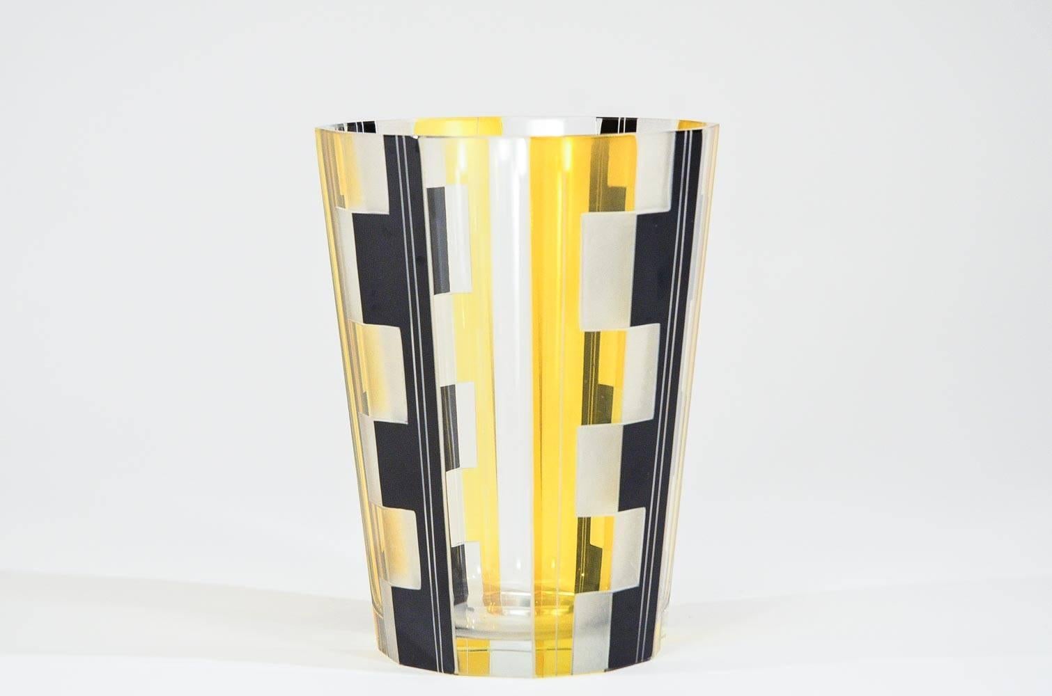 This classic example of Art Deco glass that was prominent and popular in the 1910-1920's is both functional and decorative. The combination of clear, vibrant sunflower yellow and black creates the visual end product. It is panel cut with 12