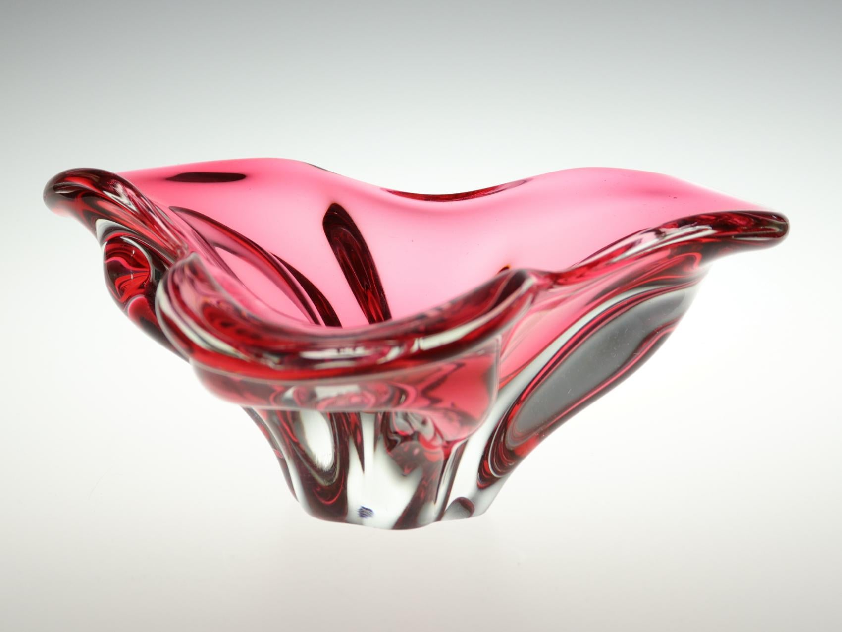 This wonderful massive art glass bowl made in red color glass with clear massive base was designed by Josef Hospodka and made in the 1960s by Chribska glasswork.
The Chribska Glassworks, full name Sklarna Chribska, was founded in the early