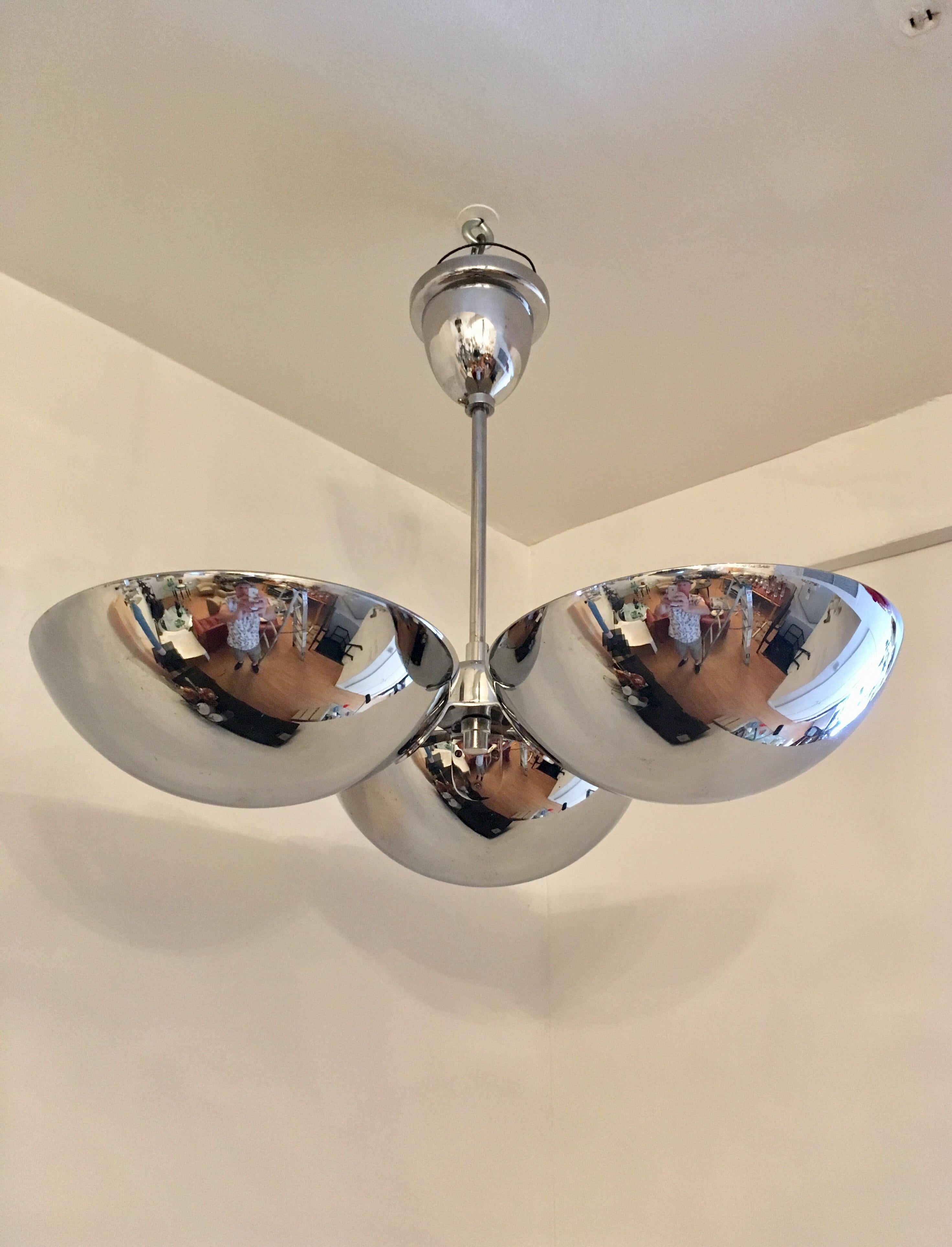 A great 1930s Bauhaus polished chrome flush ceiling light or hanging pendant. The fixture is composed of three half domes each with a porcelain 120w light socket. All rewired. Ceiling pole can be shortened or lengthened.