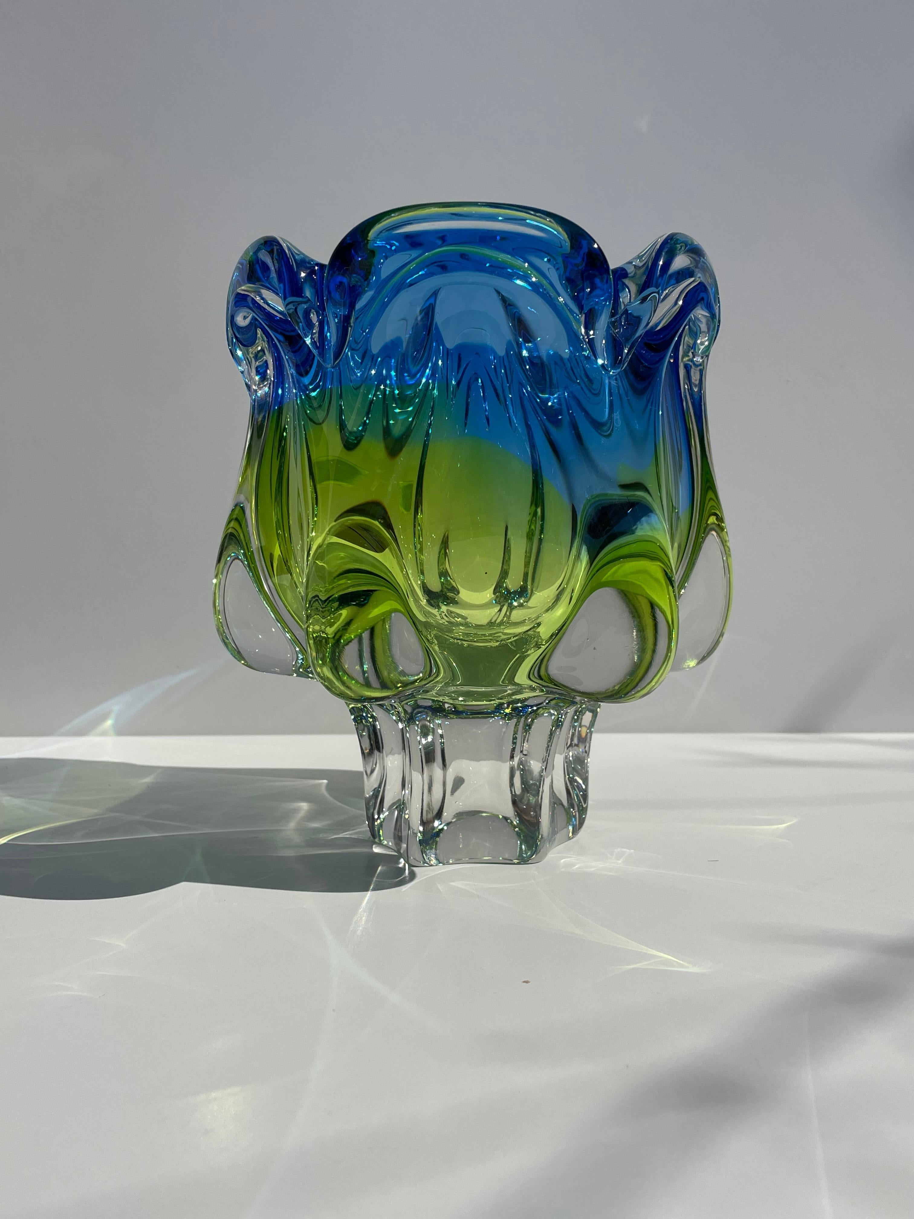 Bohemian large and heavy mouthblown decorative encased crystal art vase in bright blue, green and yellow colors. Soft organic shapes on clear solid base. Manufactured by Bohemia Crystal in Czechoslovakia in the 1970s. Original label on one side.