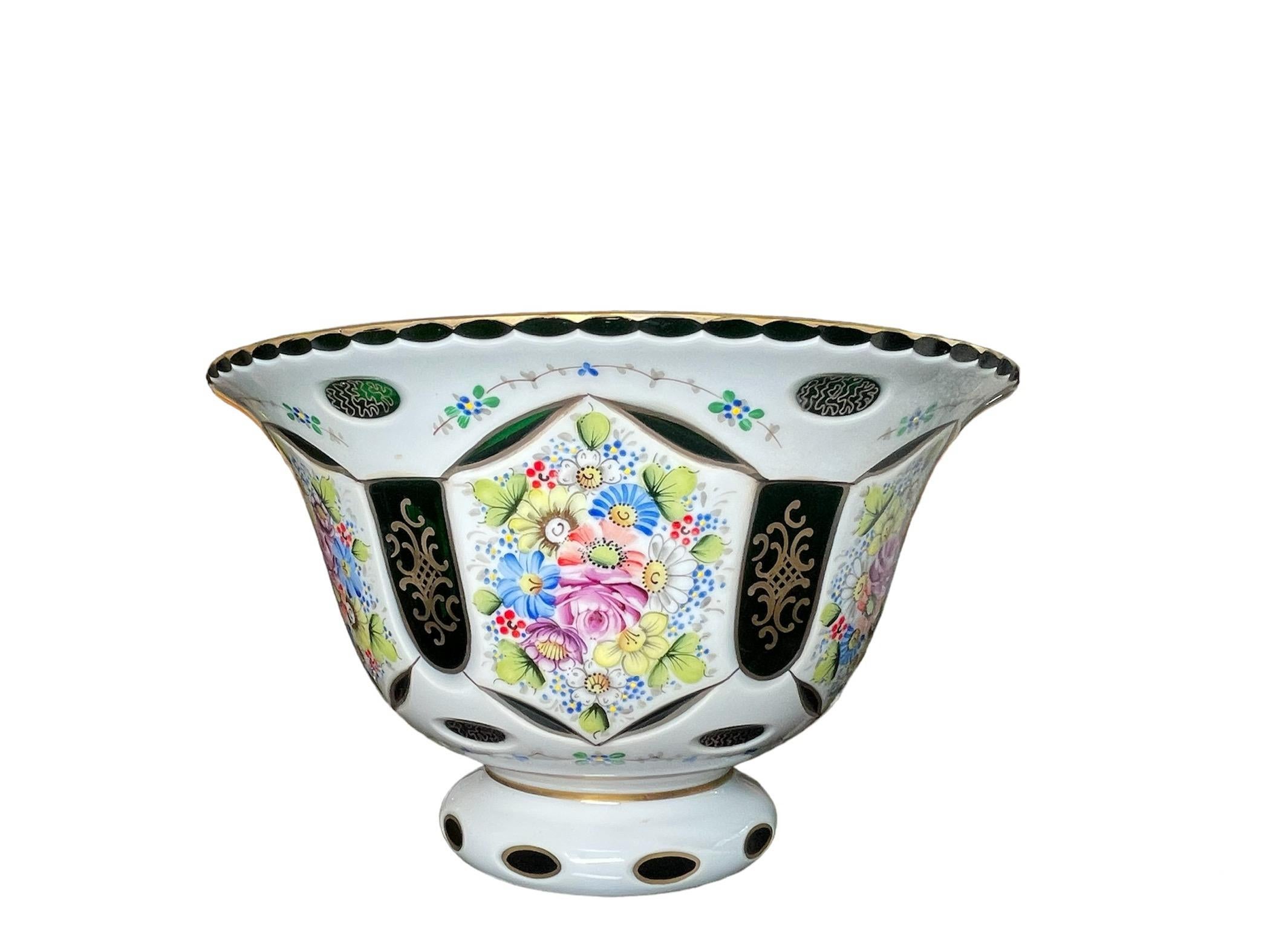 This is a Czech Bohemian White Cut to Green Glass Hand Painted Vase. It depicts an upside down bell shaped white cut to green glass vase decorated with bouquets of flowers all around. The green glass is also adorned with a gilt scrolls patterns.