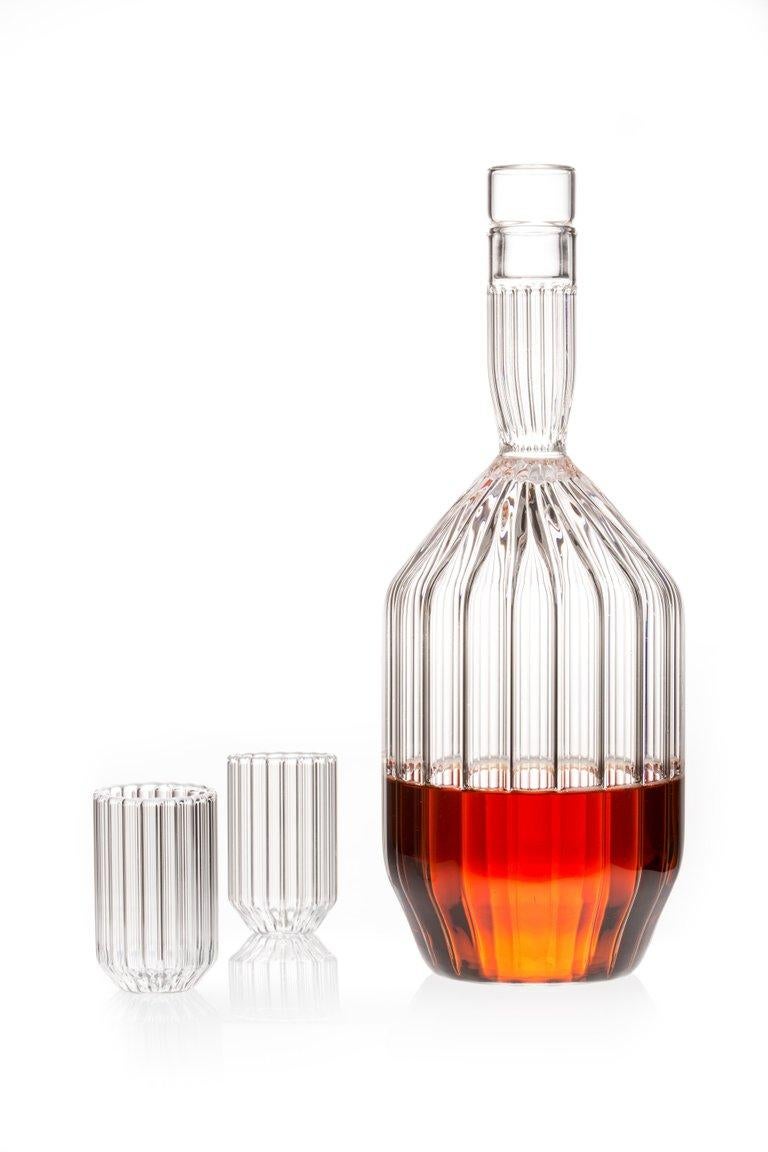 Fluted Margot decanter and two Dearborn liqueur shot mini clear glass set 

Entirely hand-formed without the use of molds, the contemporary minimal Margot decanter is an ideal companion to any evening spent enjoying your favourite port, scotch,