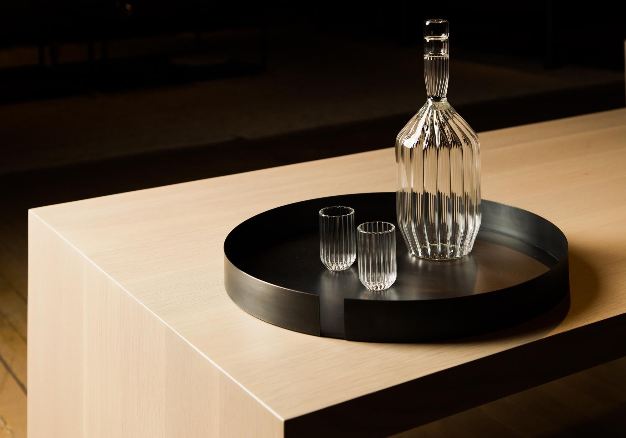 Fluted Margot decanter and two Dearborn liqueur shot mini clear glass set

Entirely hand-formed without the use of molds, the contemporary minimal Margot decanter is an ideal companion to any evening spent enjoying your favorite port, scotch,
