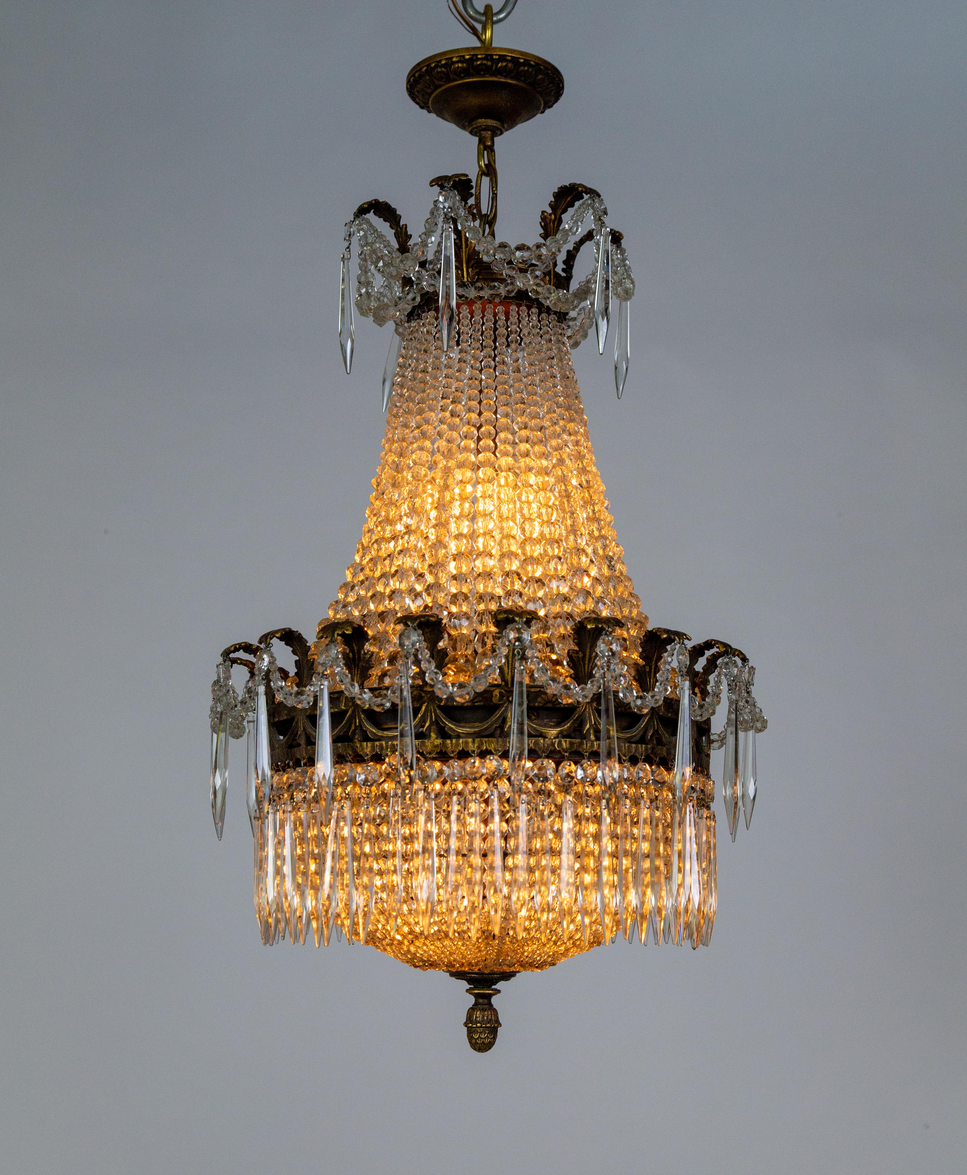 A Bohemian Tent and Bag, or Sack of Pearls chandelier made of hundreds of crystal strands.  This one is particularly special with a skirt of spear-shaped leaded crystals and beaded garlands swooping from the crown and cast bronze band of sprouting