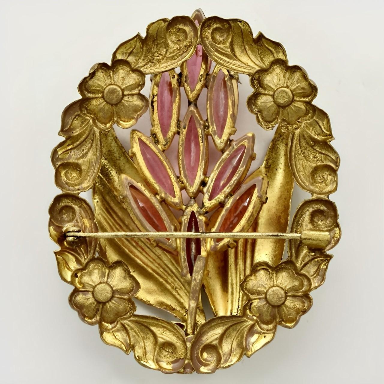 Beautiful Czech gilt metal floral brooch, with lovely pink glass stones. Measuring length 5.9 cm / 2.3 inches by 4.8 cm / 1.8 inches. The brooch is in very good condition. There is wear to the gilt metal.

This is a wonderfully stylish Czech brooch