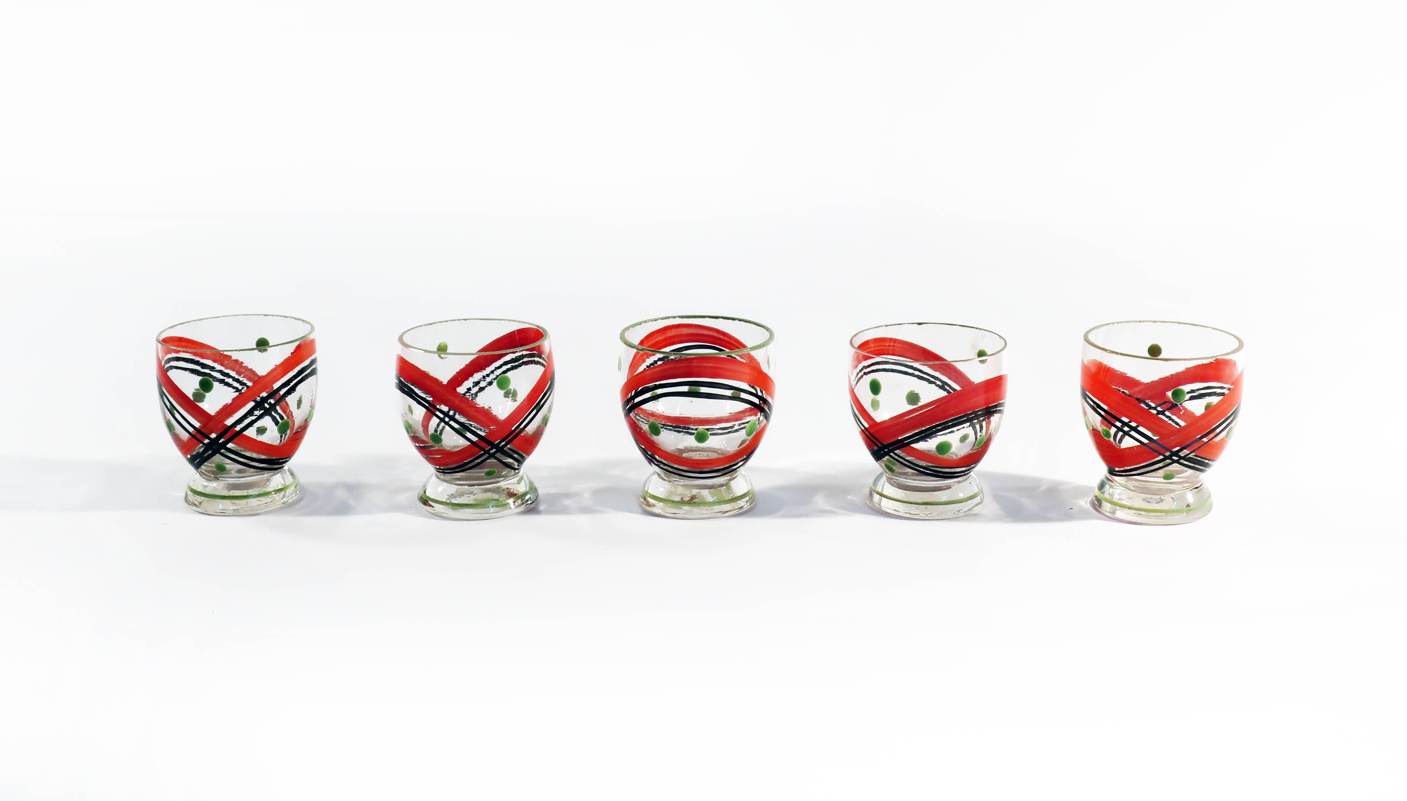 With clear glass and red, black, and green coloring, this midcentury Czech glass decanter set says nothing if not 