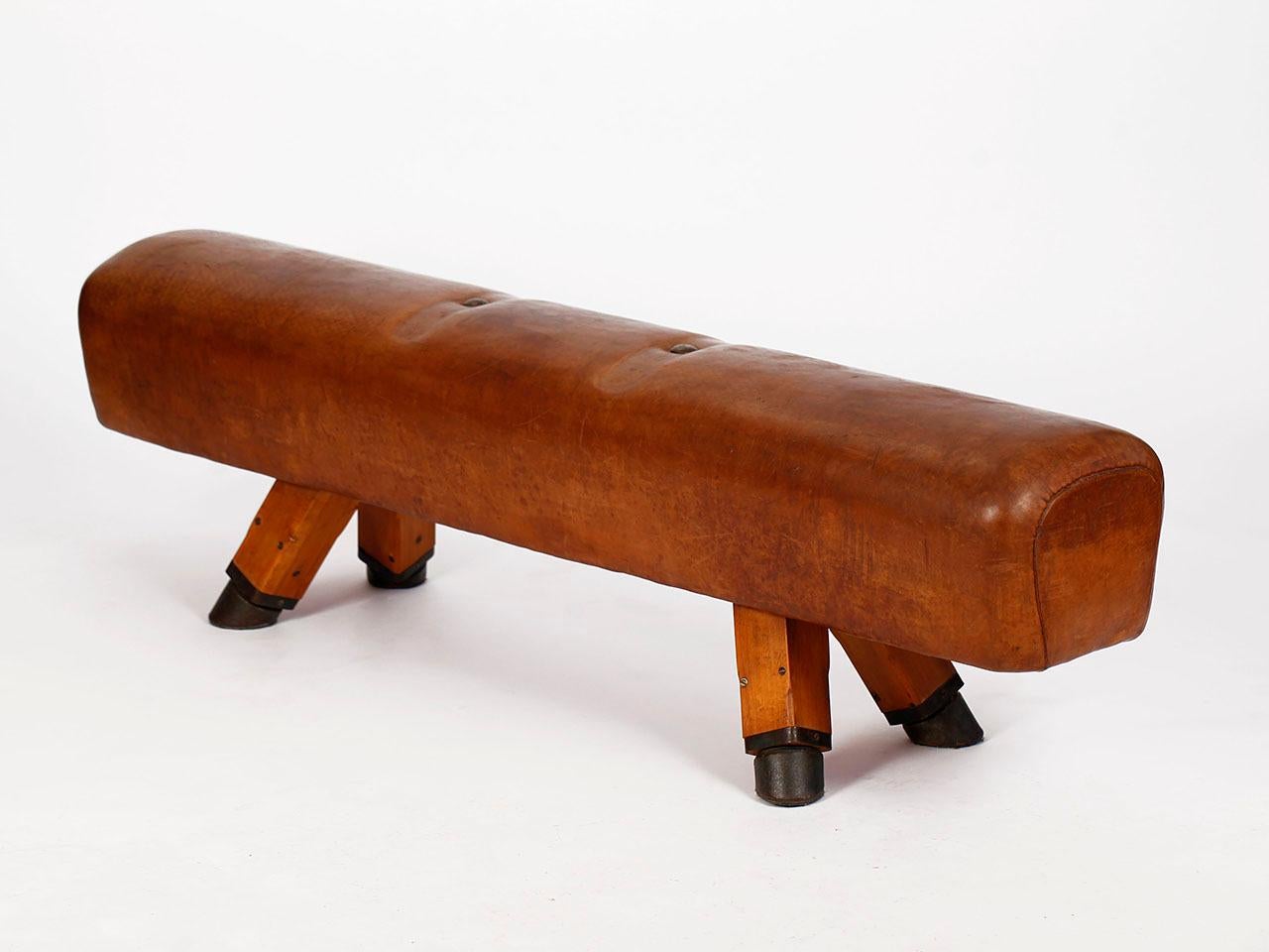 Pommel horse from former Czechoslovakia. It has been shortened to a height of 51 cm. The iron feet are preserved. The thick leather has been cleaned, restored wood surface and the patina was retained. Very good vintage condition. Completely