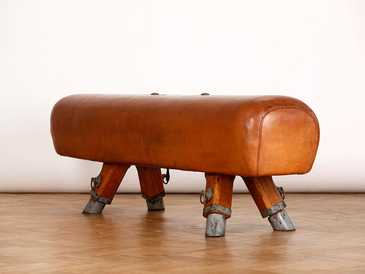 Pommel horse from former Czechoslovakia. It has been shortened to a height of 54 cm. The iron feet are preserved. 
He has extra length of 193cm. The thick leather has been cleaned, restored wood surface and the patina was retained. Very good vintage