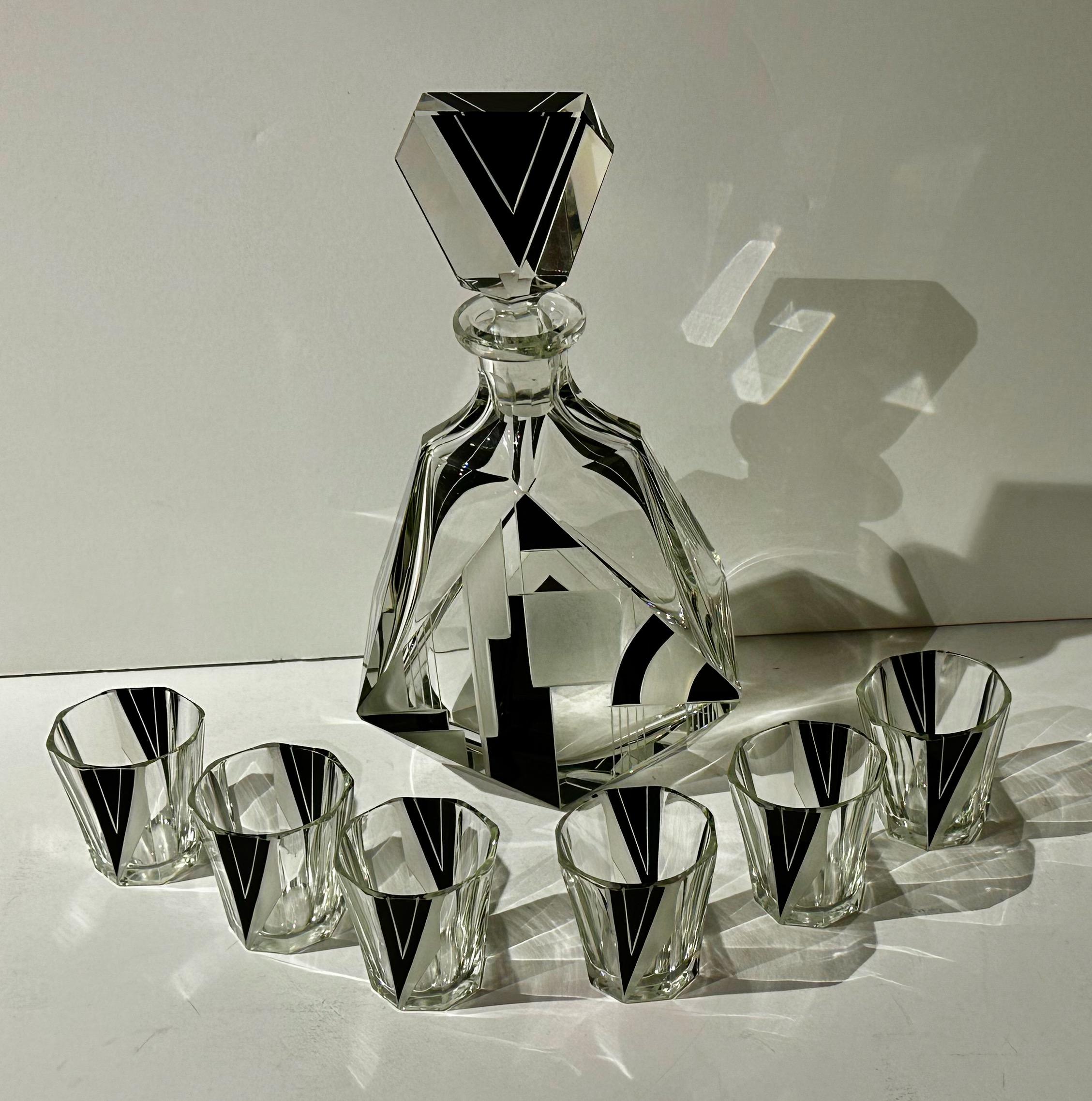 An Art Deco Modernist Decanter made in Czechoslovakia in the early 1930s with a dramatic black glass and etched design. The stepped-up motif and zig-zag and triangular decorative elements kind of evoke the architecture of the famous Chrysler