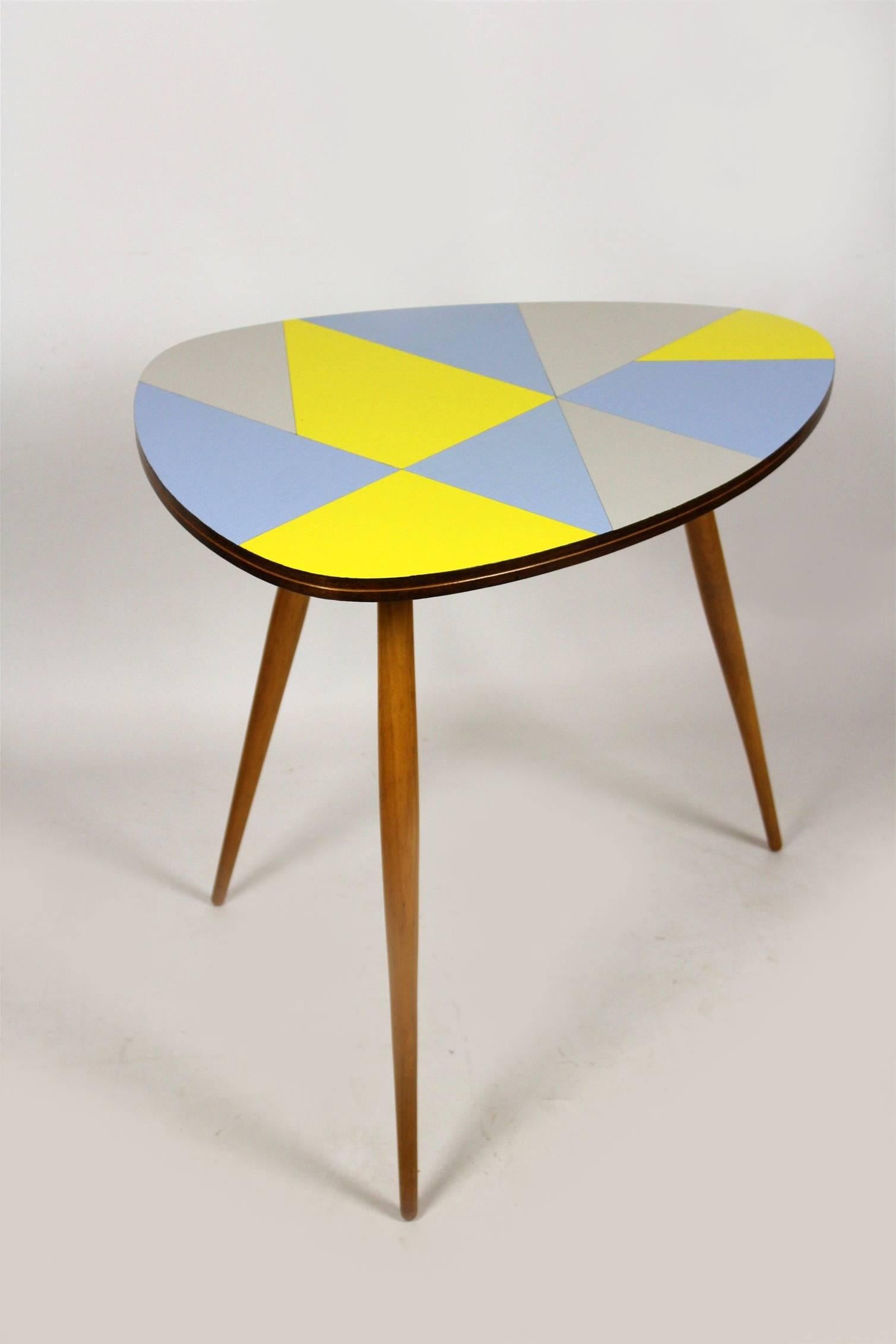 This beautiful coffee table features the original laminate top with a multicolored geometrical pattern. It has been produced in Czech Republic in the 1960s. The legs are screwed in, can be simply removed.