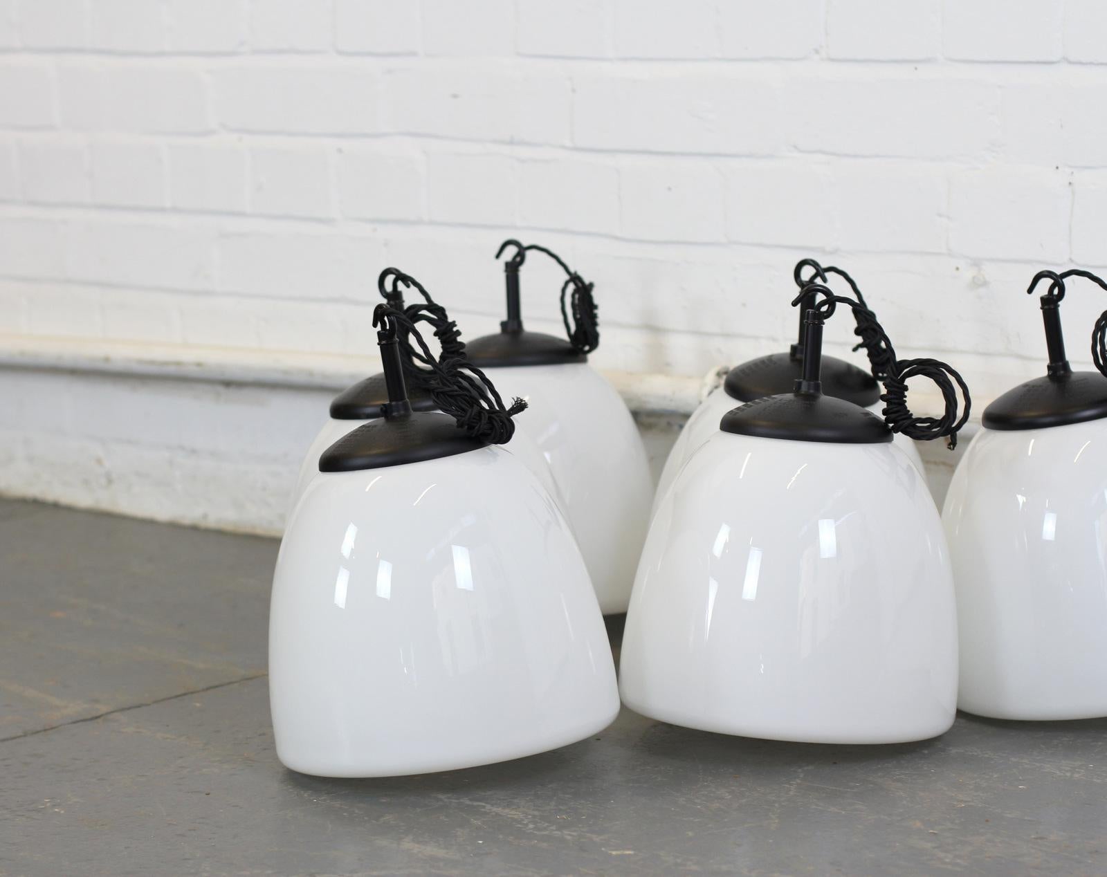 Czech opaline pendant lights, circa 1940s

- Price is per light (28 available)
- Black Bakelite tops
- Elegant shaped opaque glass
- Comes with 100cm of black twist cable and ceiling rose
- Takes E27 fitting bulbs
- Czech, circa 1940s
- 25cm