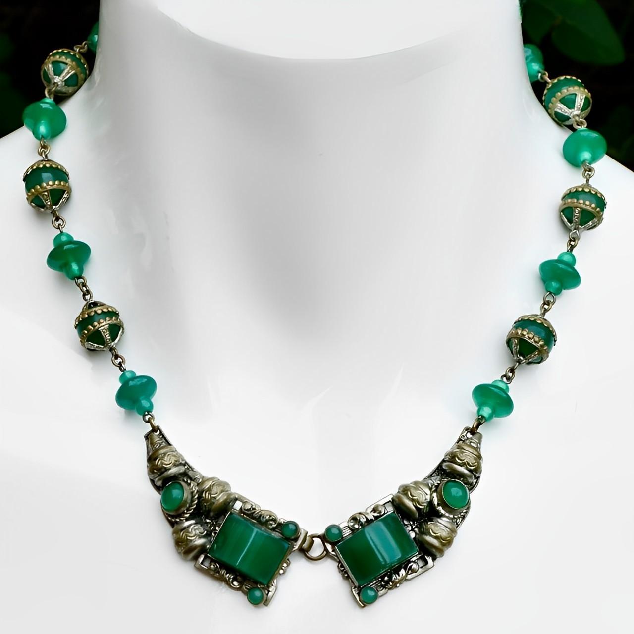Wonderful Czech ornate silver plated necklace, featuring green glass. The necklace fastens at the front. Measuring necklace length 43.2 cm / 17 inches. Most of the silver plating has worn to reveal a lovely bronze tone metal underneath. One of the