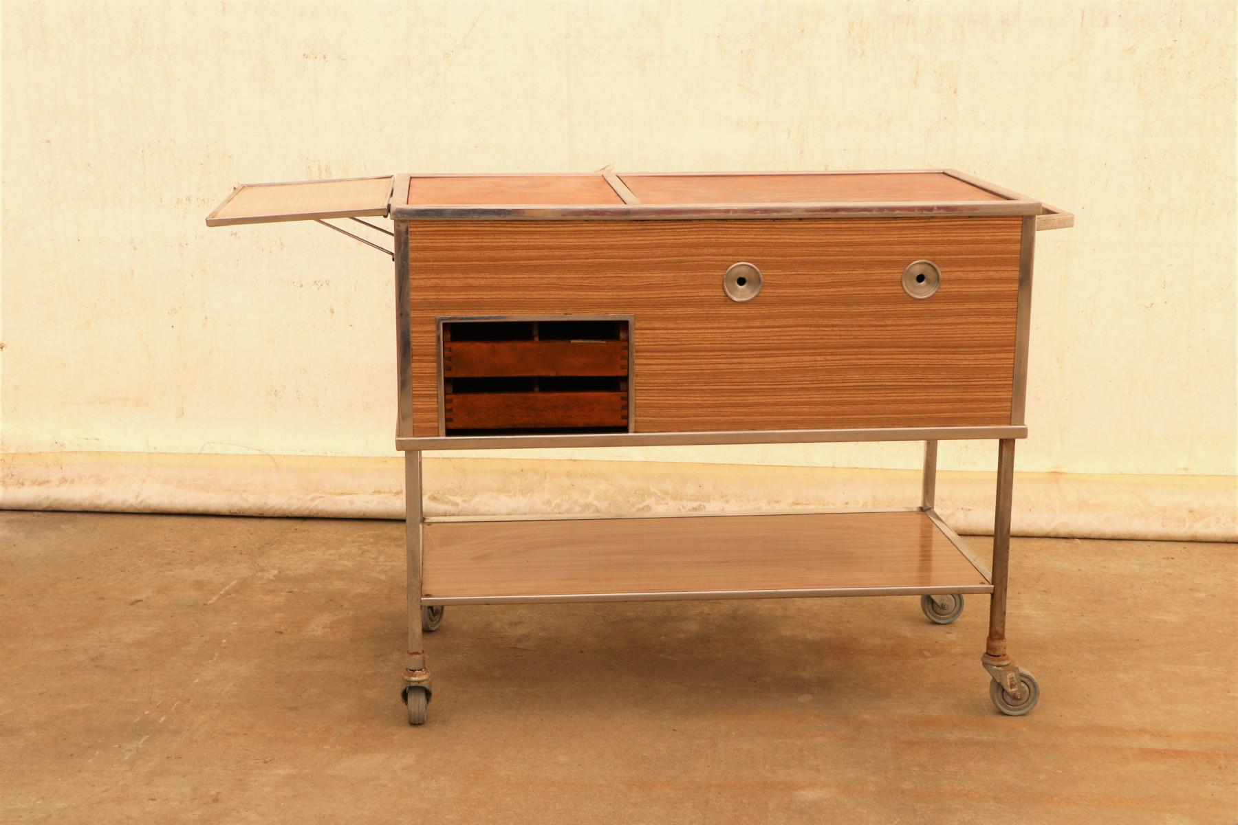 This Industrial-style serving trolley on wheels was made in the former Czechoslovakia in the 1970s. It was originally used as a serving table in the restaurant or hotel. At the moment, it is rather a great decoration for the interior.
It features