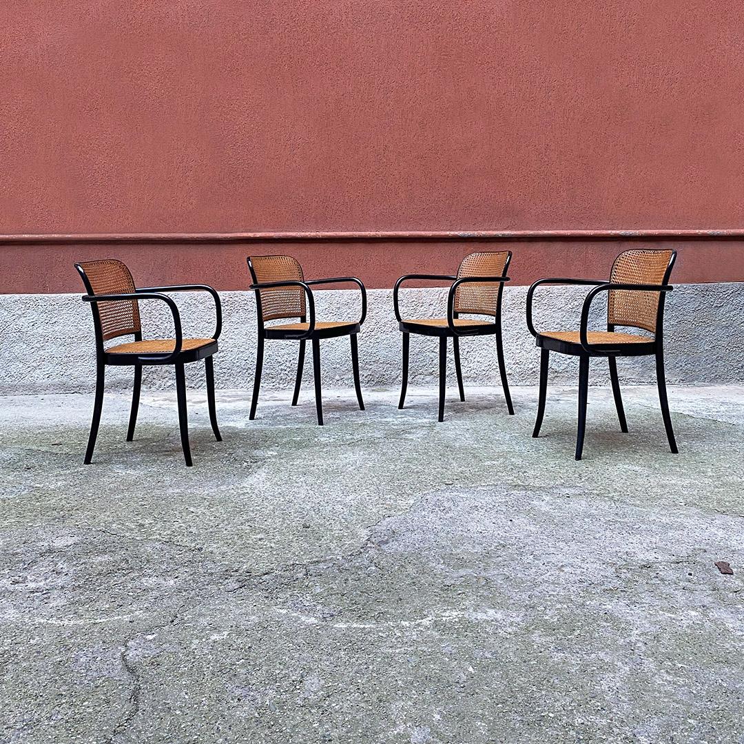 Czechoslovakian antique set of beech and Vienna straw chairs with armrests by Ligna, Czechoslovakia 1900s.
Set of four chairs in black painted beech with armrests, with seat and back in Vienna straw and saber legs.
Produced by Ligna, in
