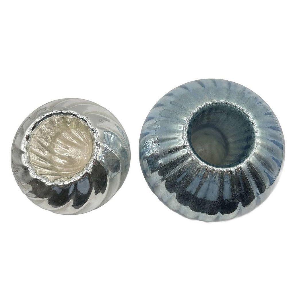 Elevate your space with these striking Czechoslovakian mercury glass candlestick holders. Featuring a cobalt blue base and silvered accents, these pieces showcase the rich craftsmanship of 19th-century Bohemian design. The shimmering mercury finish
