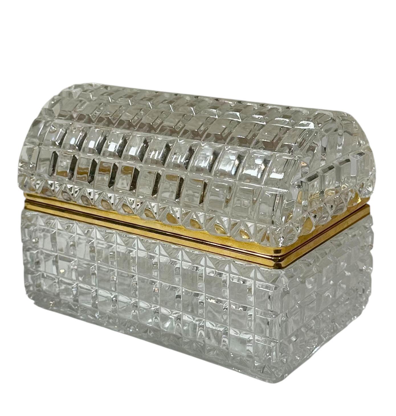 A pristine example of mid century design this cut to clear crystal box features a classic cushion form and elegant dore bronze edging. The crystal is finely faceted and reflects light with clarity and brilliance.

Remarkably the box has never been