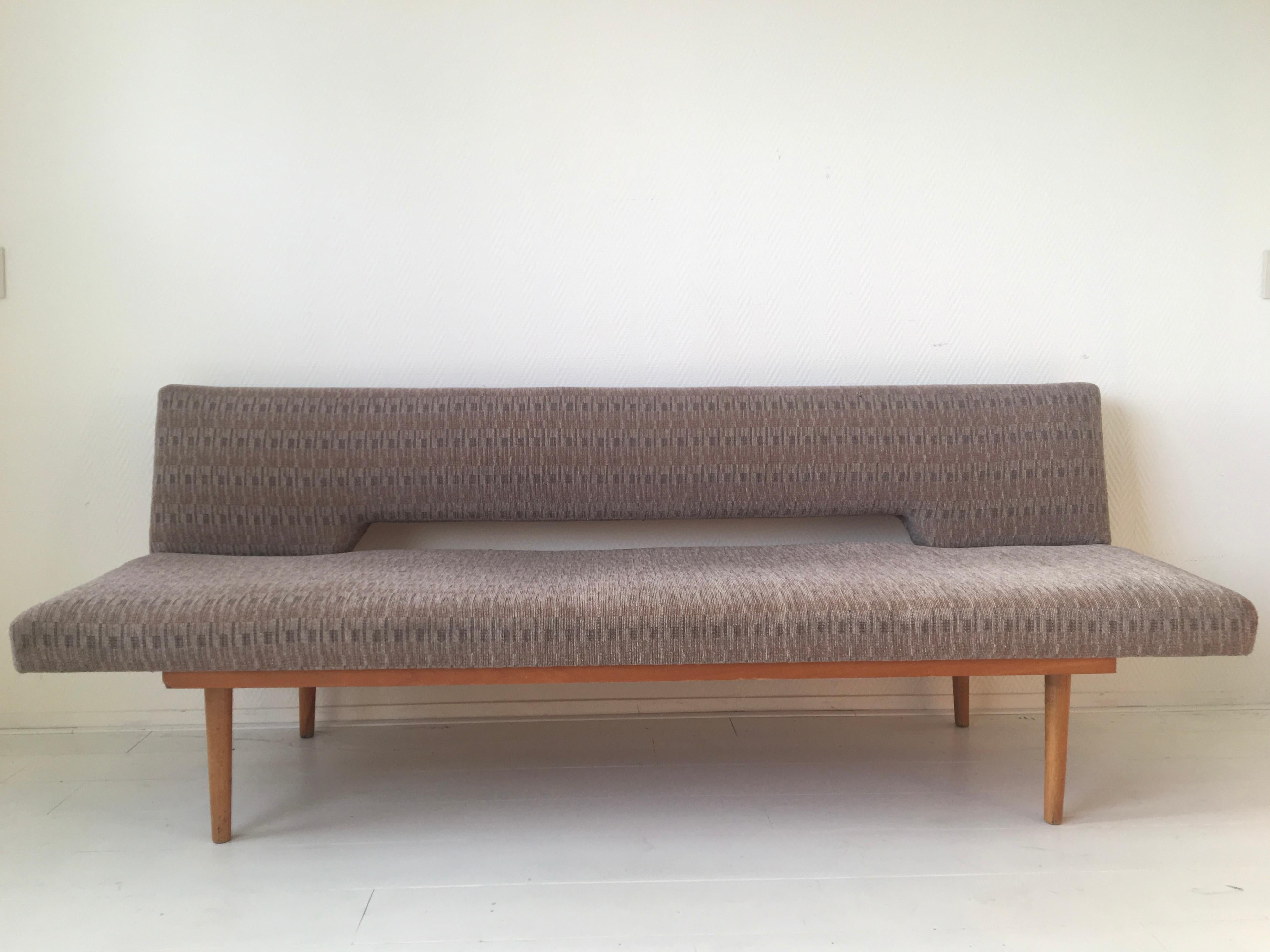Wonderful Mid-Century Modern sofa, designed by Miroslav Navratil, circa 1960s. This simple sofa can easily be changed into a bed. The sofa features a beech frame with still the original fabric. Timeless design with some wear to the fabric.