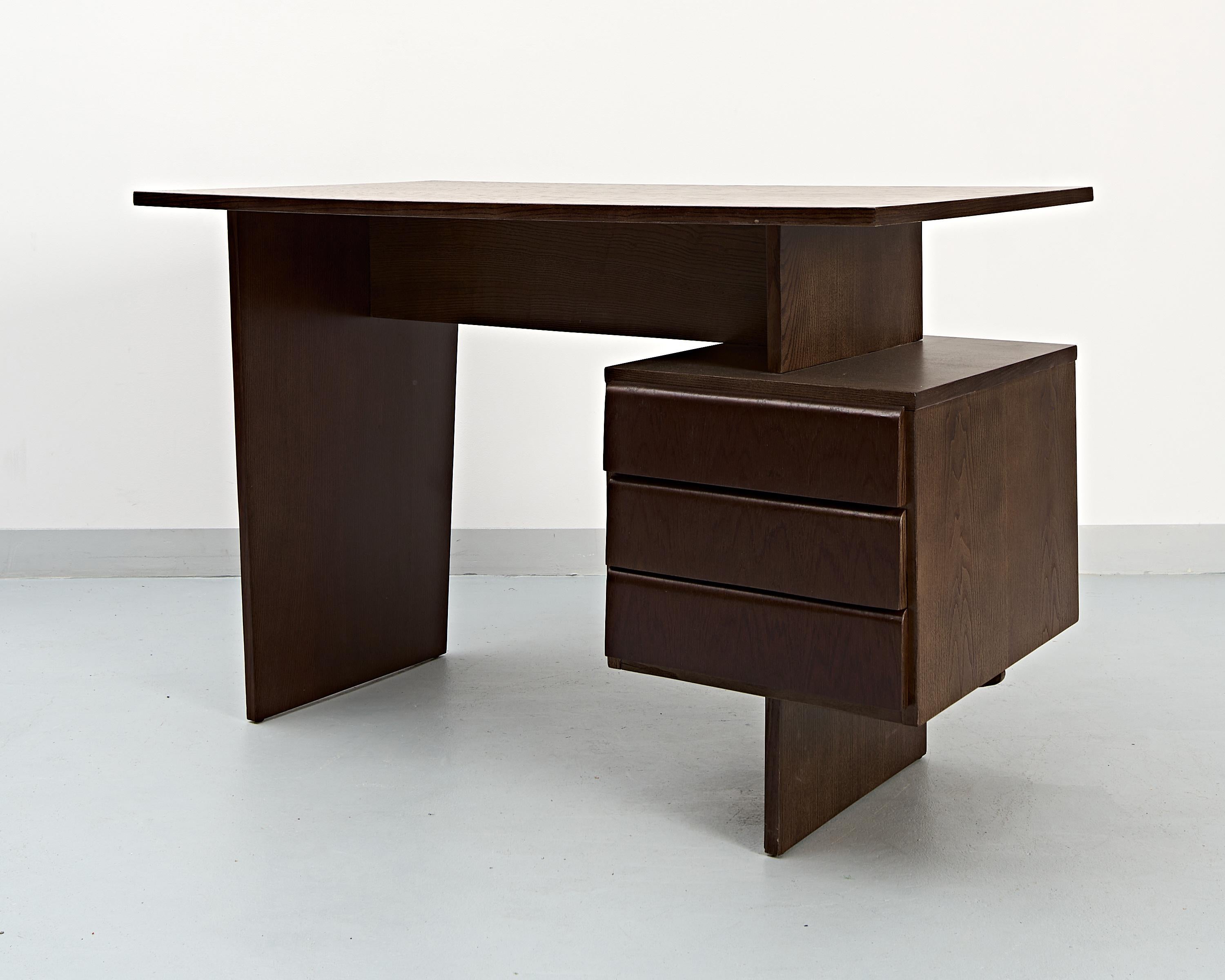 An oak desk designed by Bohumil Landsman, produced during the 1970's in former Czechoslovakia by a furniture factory Jitona. 
A striking design.
Surfaces cleaned, stained and lacquered. 1990Beautiful restoration work.