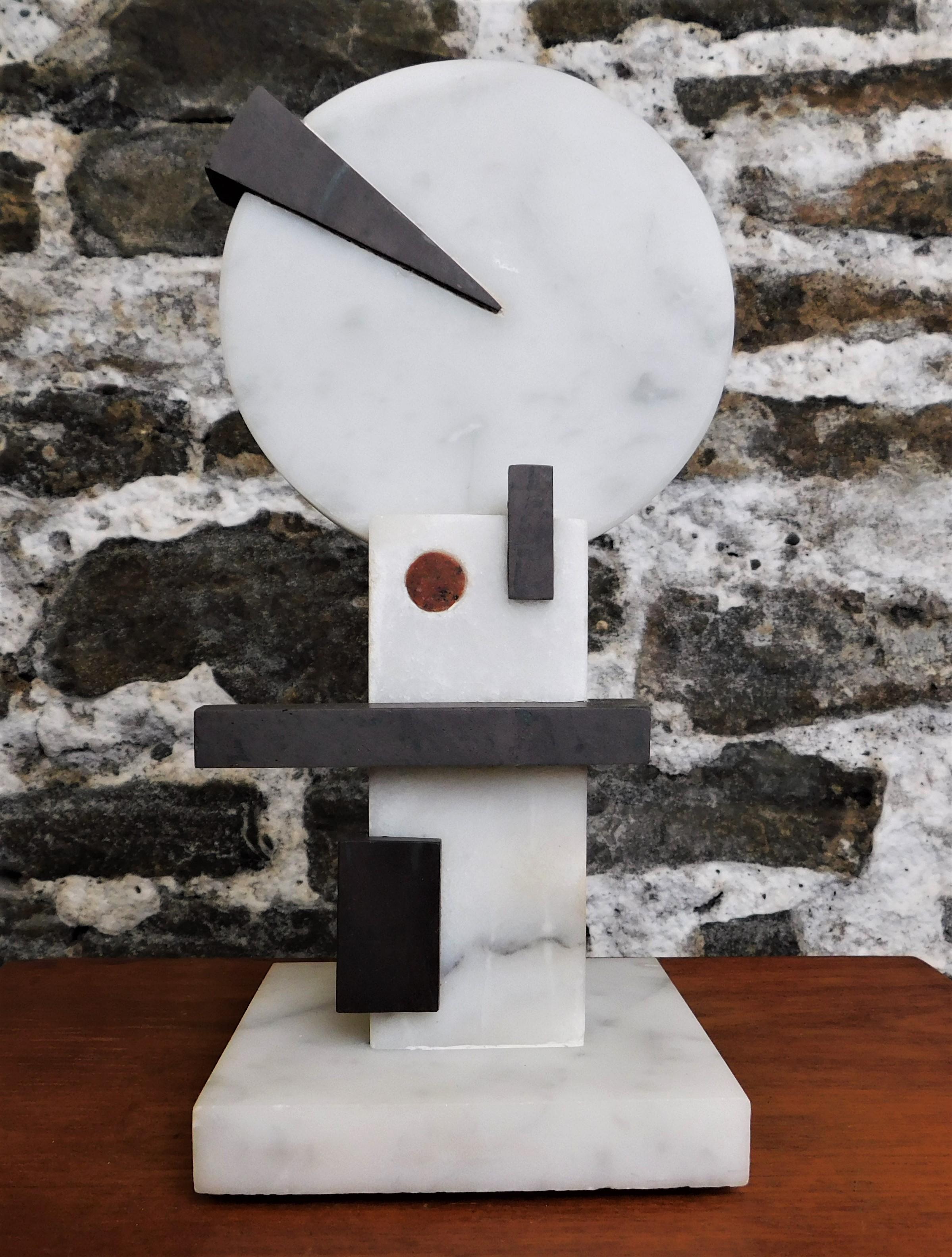 This contemporary abstract marble sculpture is by Czeslaw Budny, a Polish-Canadian artist in the constructivist style circa 2021. This unique sculpture is made of marble. Budny utilizes the simplicity of shapes such as the cube, circle and triangle