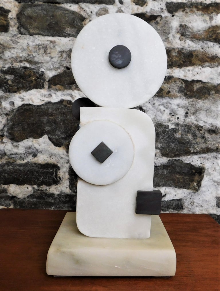 This contemporary abstract marble sculpture is by Czeslaw Budny, a Polish-Canadian artist in the constructivist style circa 2021. This unique sculpture is made of marble. Budny utilizes the simplicity of shapes such as the cube, circle and triangle
