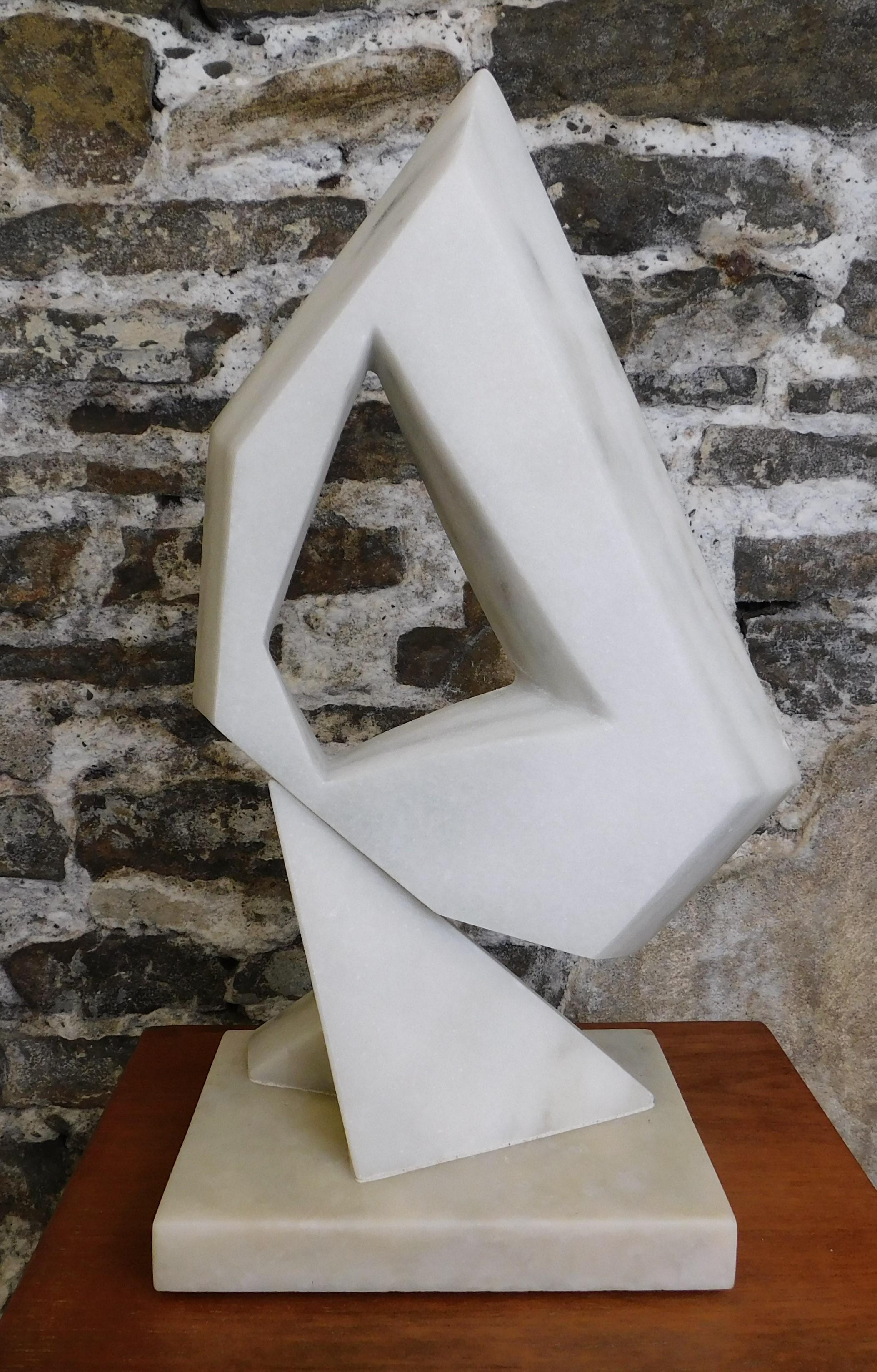 This contemporary abstract marble sculpture is by Czeslaw Budny, a Polish-Canadian artist in the constructivist style circa 2021. This unique sculpture is made of marble. Budny utilizes the simplicity of shapes such as the cube, circle and triangle
