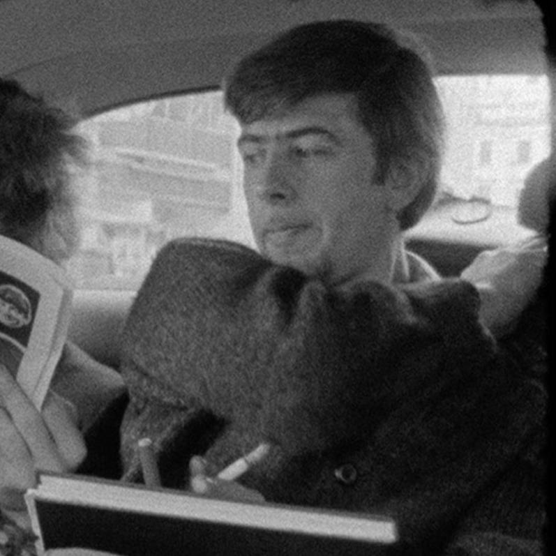 Bob Dylan reading Melody Maker with John Mayall looking on London 1965  - Photograph by D.A. Pennebaker