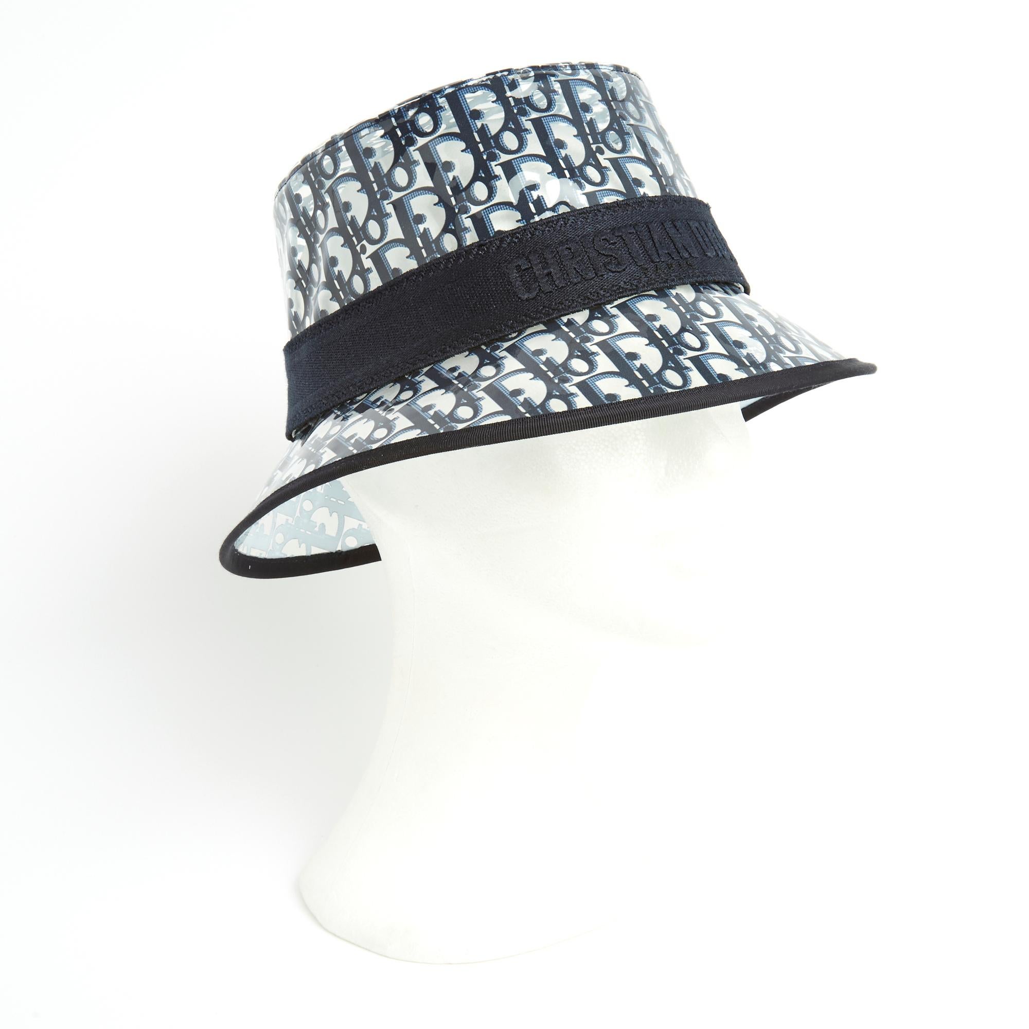 Christian Dior hat model D-Bobby French Oblique with small brim in transparent PVC printed navy blue Oblique motif, ribbon inscribed Christian Dior Paris. Size 58. The hat is probably from private sales, in perfect condition, with its original