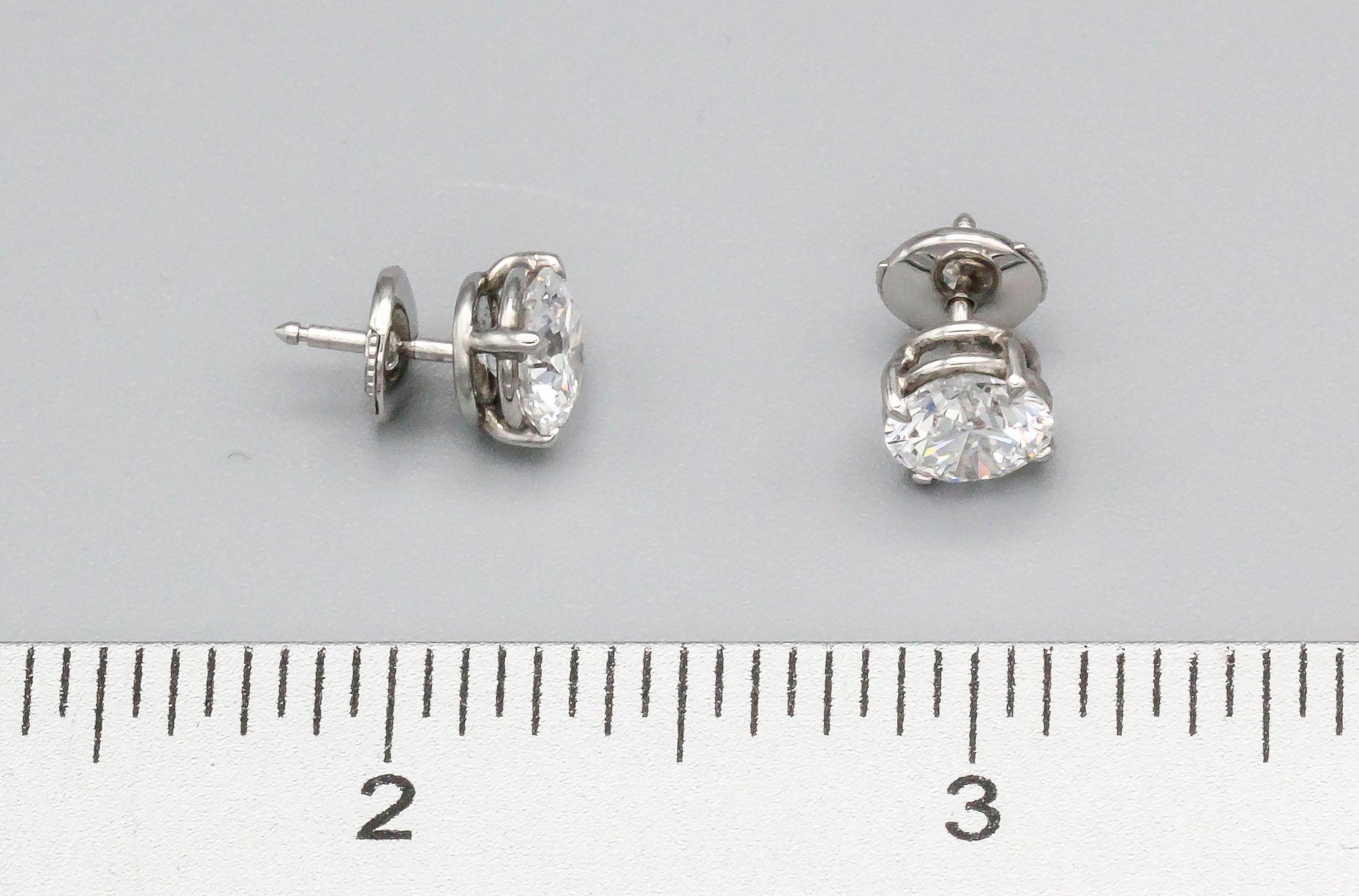 Exceptional diamond and platinum stud earrings. The first round brilliant cut diamond is 1.55 carats in weight, D color, Internally Flawless clarity; with excellent cut grade, excellent polish, and excellent symmetry .  The second round brilliant