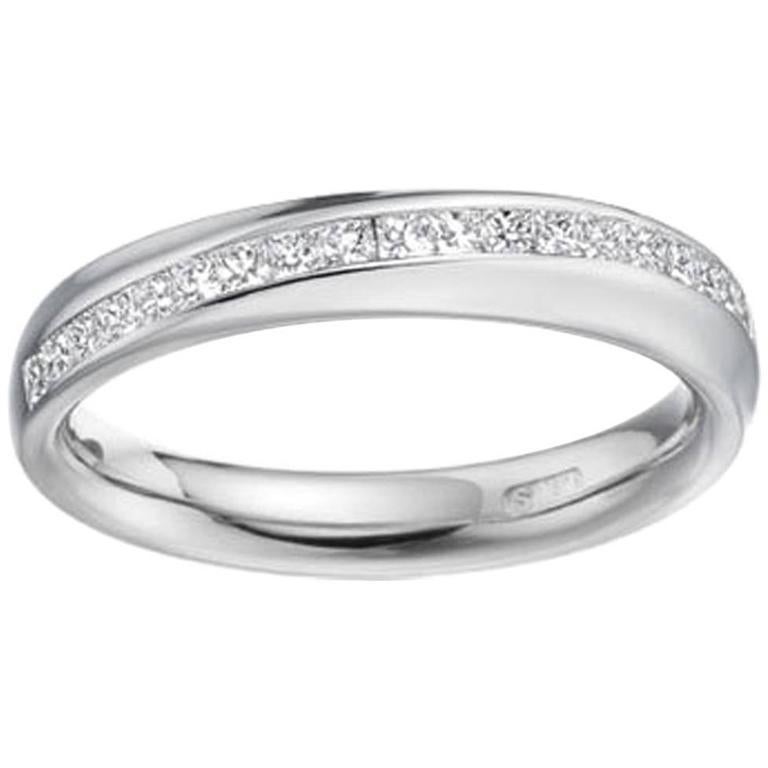 A clean-lined, contemporary wedding or eternity ring by the UK Award Winning Designer, Paul Spurgeon.  The ring has been crafted in platinum with a swirl of princess cut diamonds in a channel setting that runs from one side of the band to the other