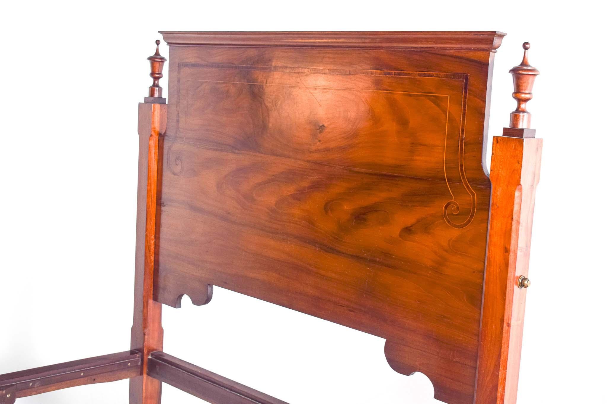 Dieses Bett aus dem 19. Jahrhundert ist ein beeindruckendes Beispiel portugiesischer Handwerkskunst, sorgfältig aus massivem Palisanderholz gefertigt und mit Intarsien aus Satinholz verziert. Das Kopfteil ist ein Zeugnis der komplizierten