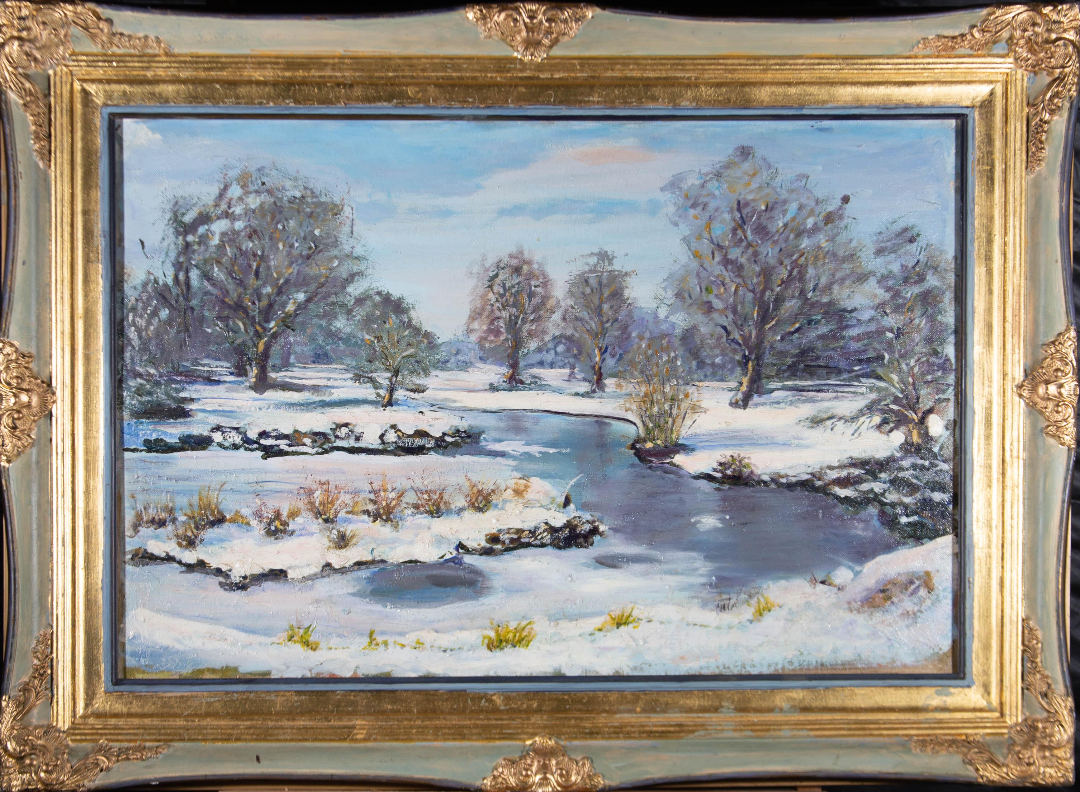 A textured oil showing a Winter landscape with a frozen stream running through snow covered fields. The painting is presented in a contemporary gilt and blue painted frame with swept corners and rail. There is a label at the reverse with the