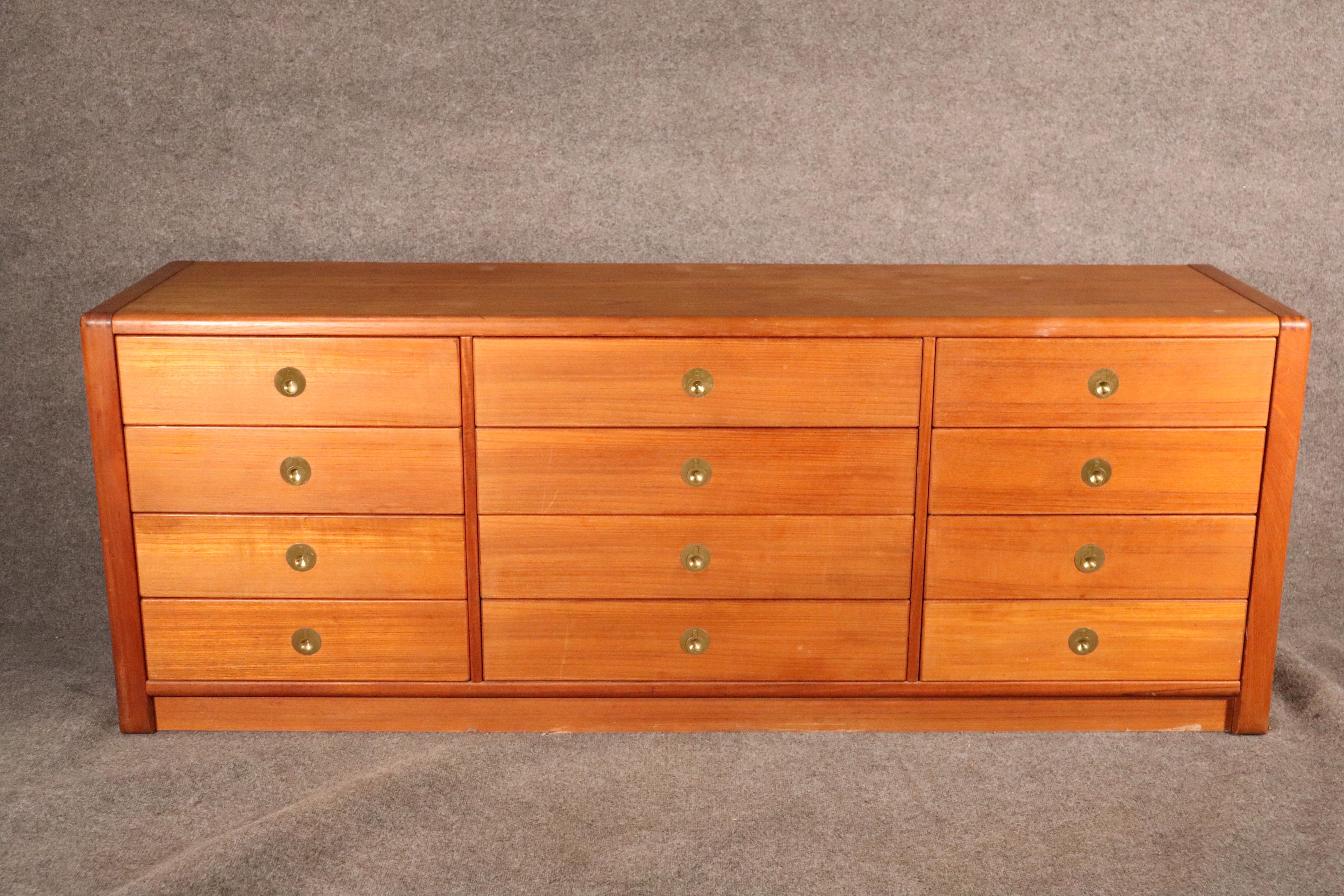 Mid-Century Modern Danish dresser by D-Scan for their 'Captain' collection. Soft rounded edges with brass hardware. Twelve drawers give plenty of bedroom storage.
Please confirm location.
 