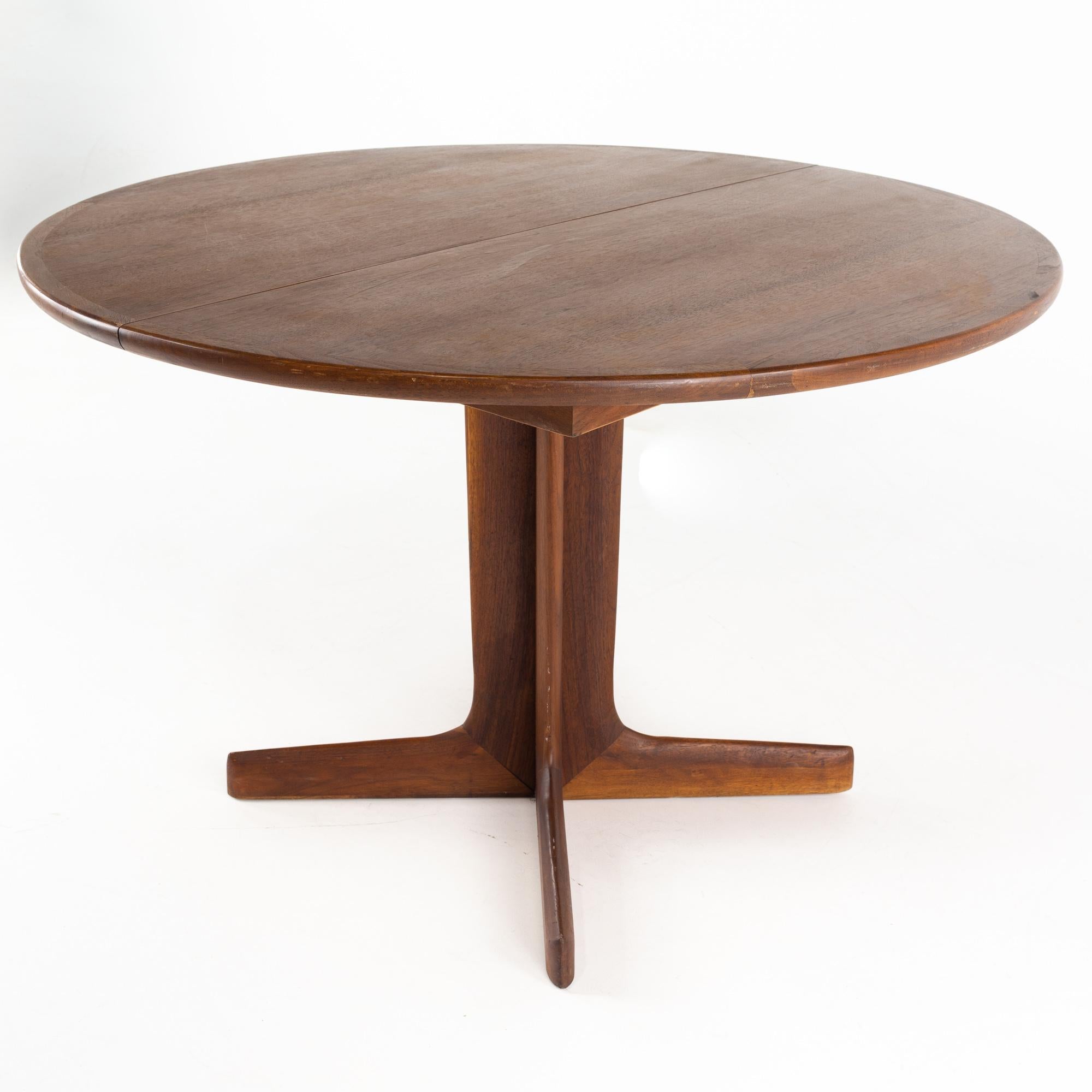 D Scan Style mid century teak pedestal base round dining table

This table measures: 45 wide x 45 deep x 29.5 inches high, with a chair clearance of 28.5 inches

All pieces of furniture can be had in what we call restored vintage condition. That