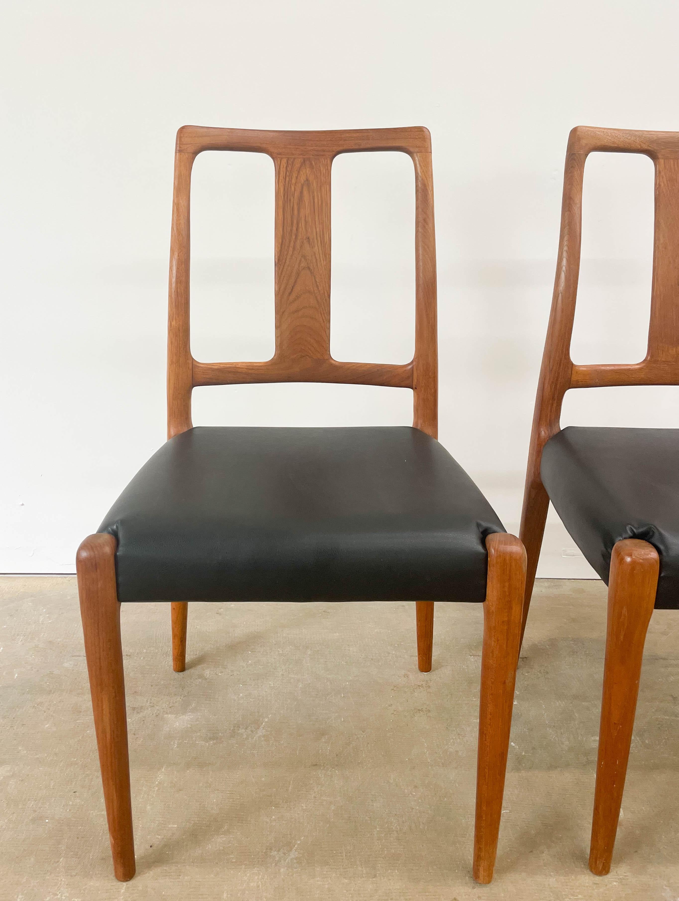 This beautiful set of D-Scan Mid-Century Modern teak dining chairs would look perfect around a dining table. Each is made from solid teak, boasts a sculptural frame, and has newly added vegan leather seats to ensure comfort for decades to come. The