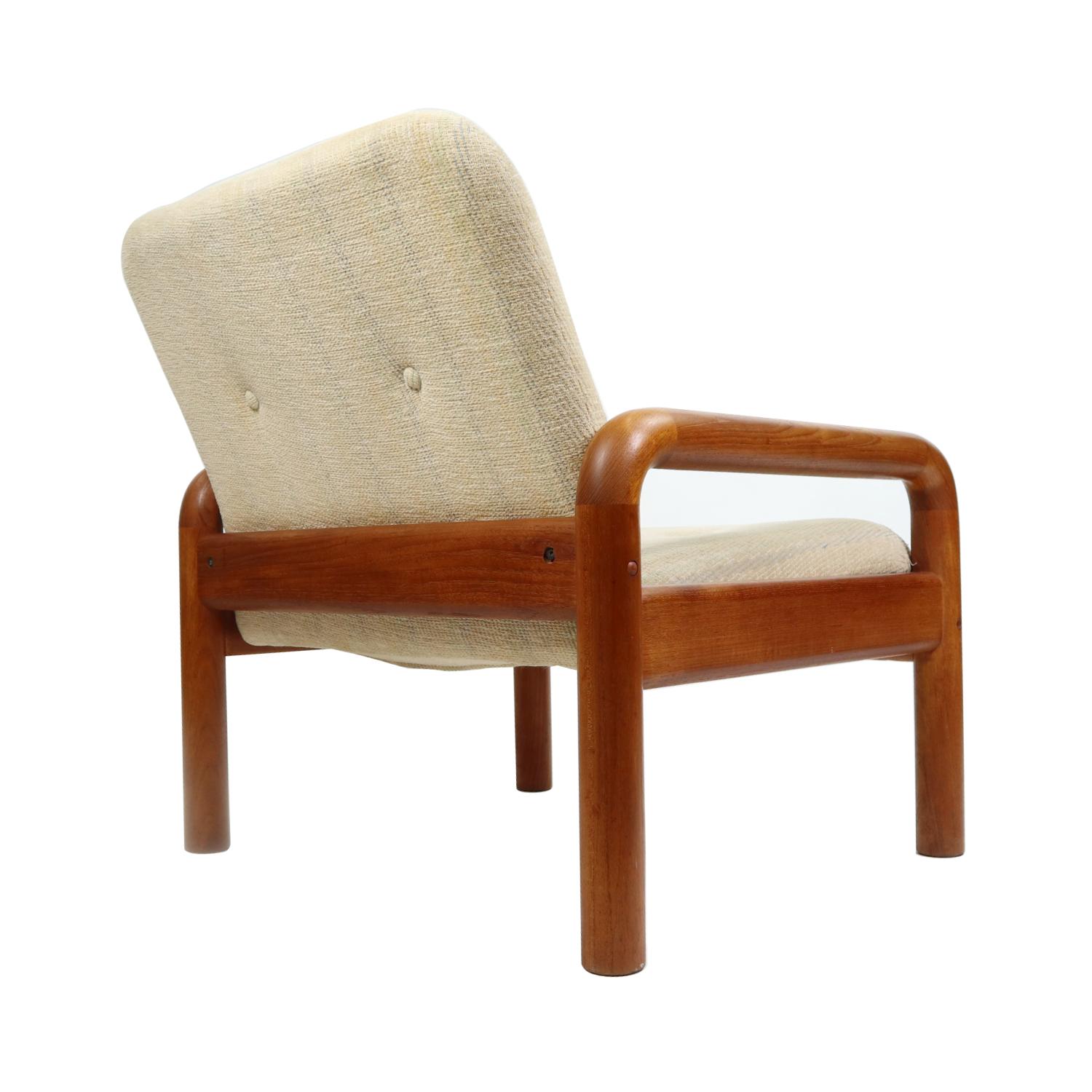 Vintage Danish modern armchair by D-Scan. The solid teak wood frame supports the light beige upholstered cushions. Quality is in the details with the choice of durable, attractive teak wood and plush fabric. The light beige fabric has a soft, almost