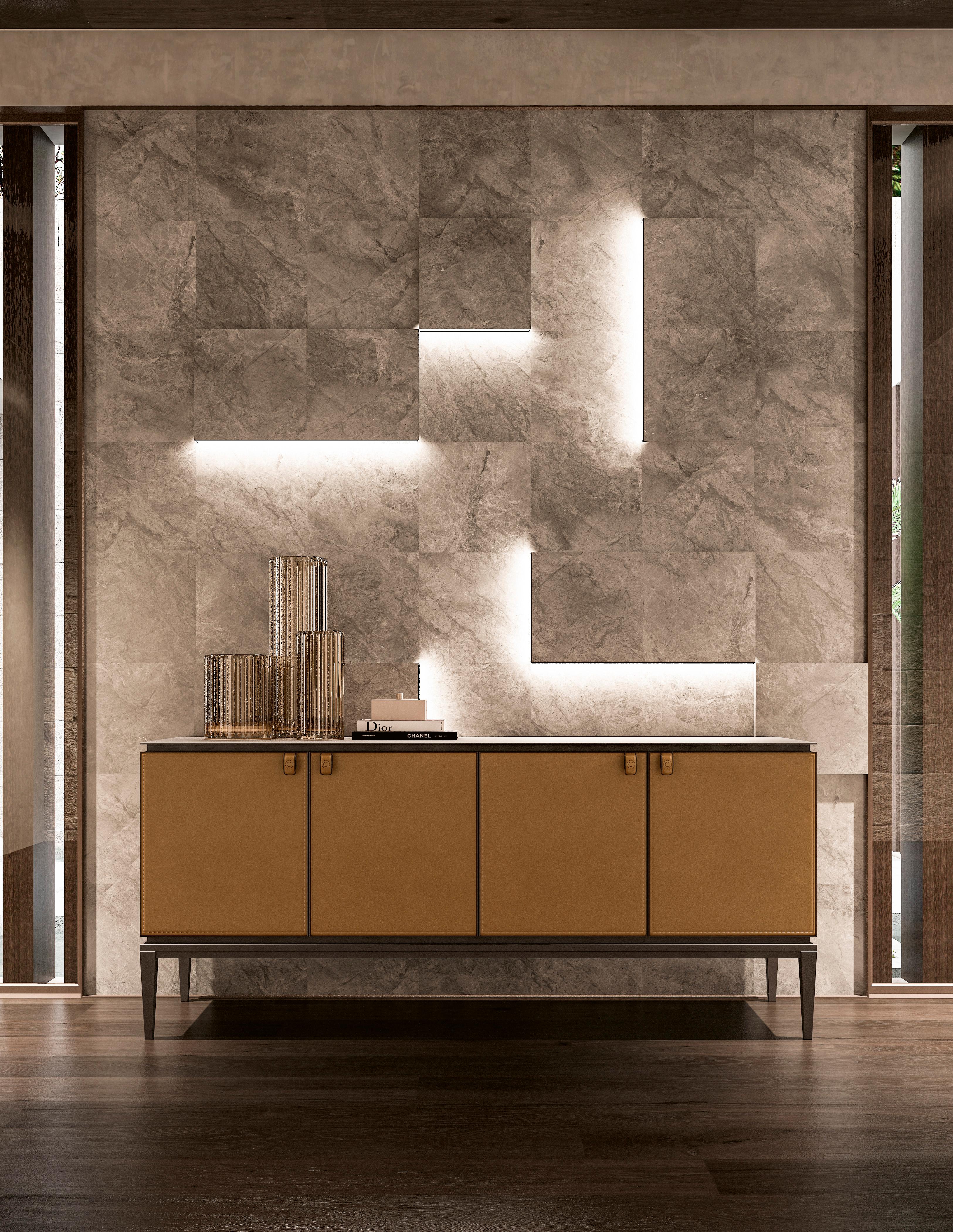 A lacquered sideboard with a metal top and front doors covered in saddle leather. The structure is sleek and modern, featuring a smooth lacquered finish that adds a touch of elegance. The metal top provides a sturdy and industrial contrast, while
