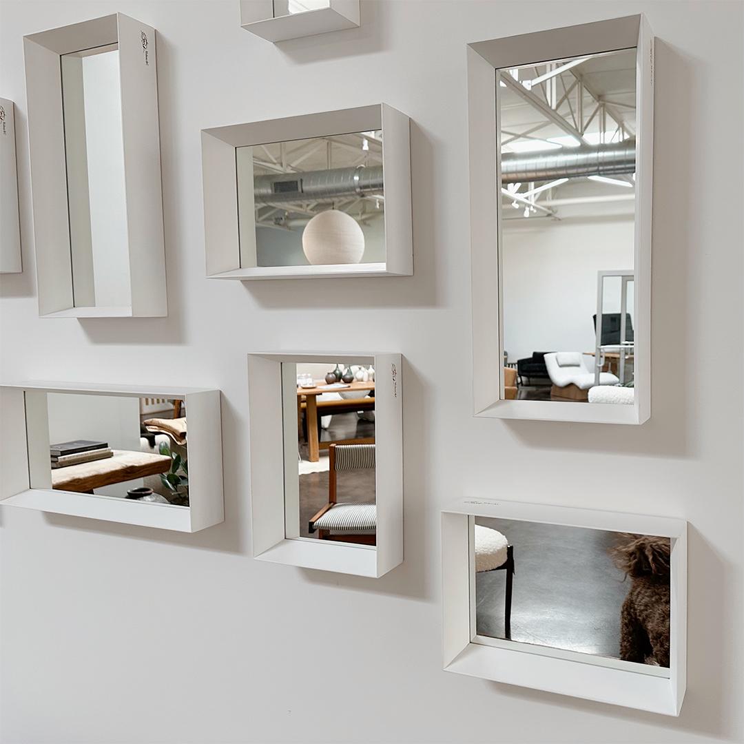 A set of 9 mirrored hand-painted white solid wood frames vary in size: 5 medium, 3 large, and 1 small. What we love about this installation is the configuration and arrangement of the mirrors are endless. 

Molteni & C + Gio Ponti
The manufacturers,