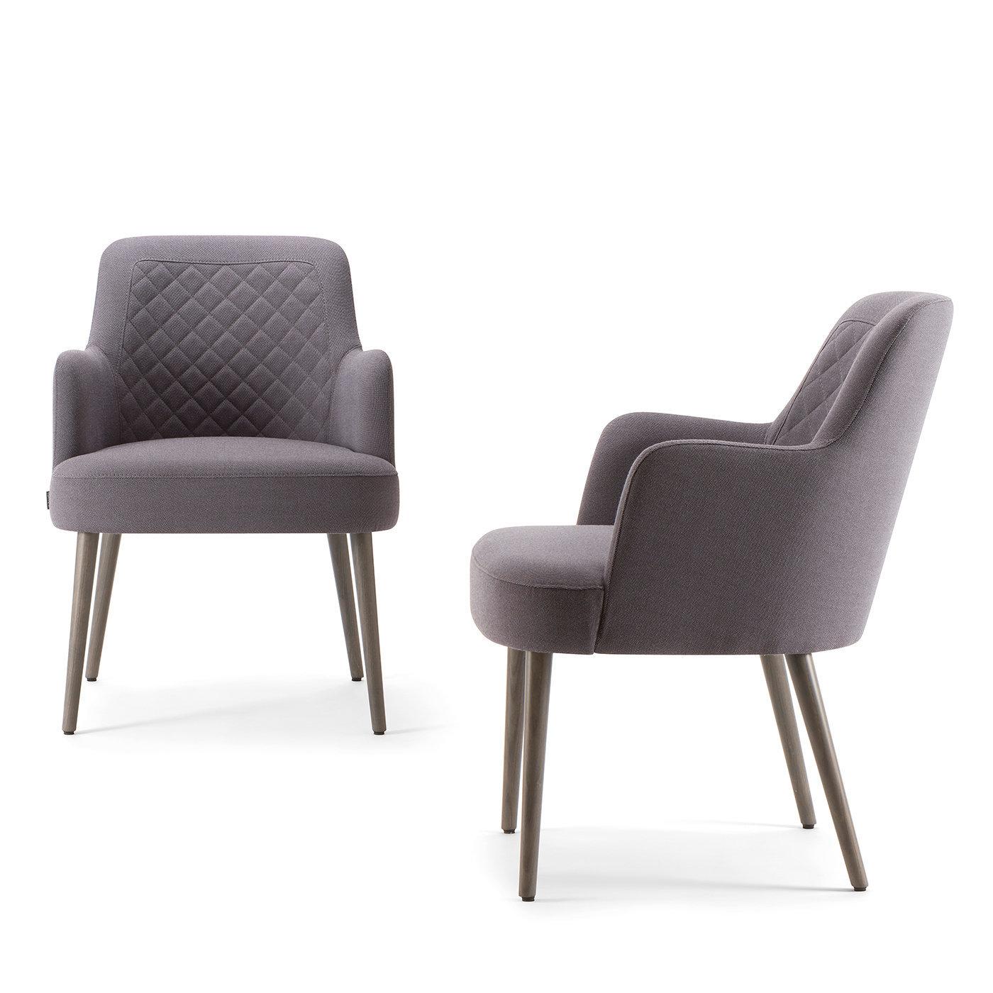 With its remarkable shape and thoughtful details, this retro-inspired armchair is a creative way to incorporate an exceptional vintage piece into a modern home. Standing on a 4-legged ash wood base with gray aniline finish, this armchair is