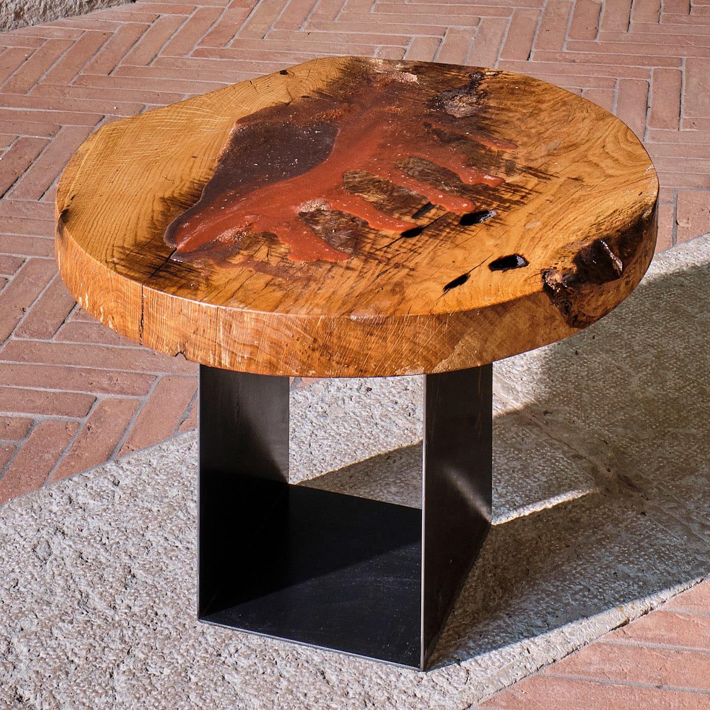 Part of the AlUla Collection comprised of one-off pieces crafted and painted by hand, this stupendous coffee table features a striking sculptural top in paulownia wood, treated with resin and acrylic to enhance its natural allure. The iron base