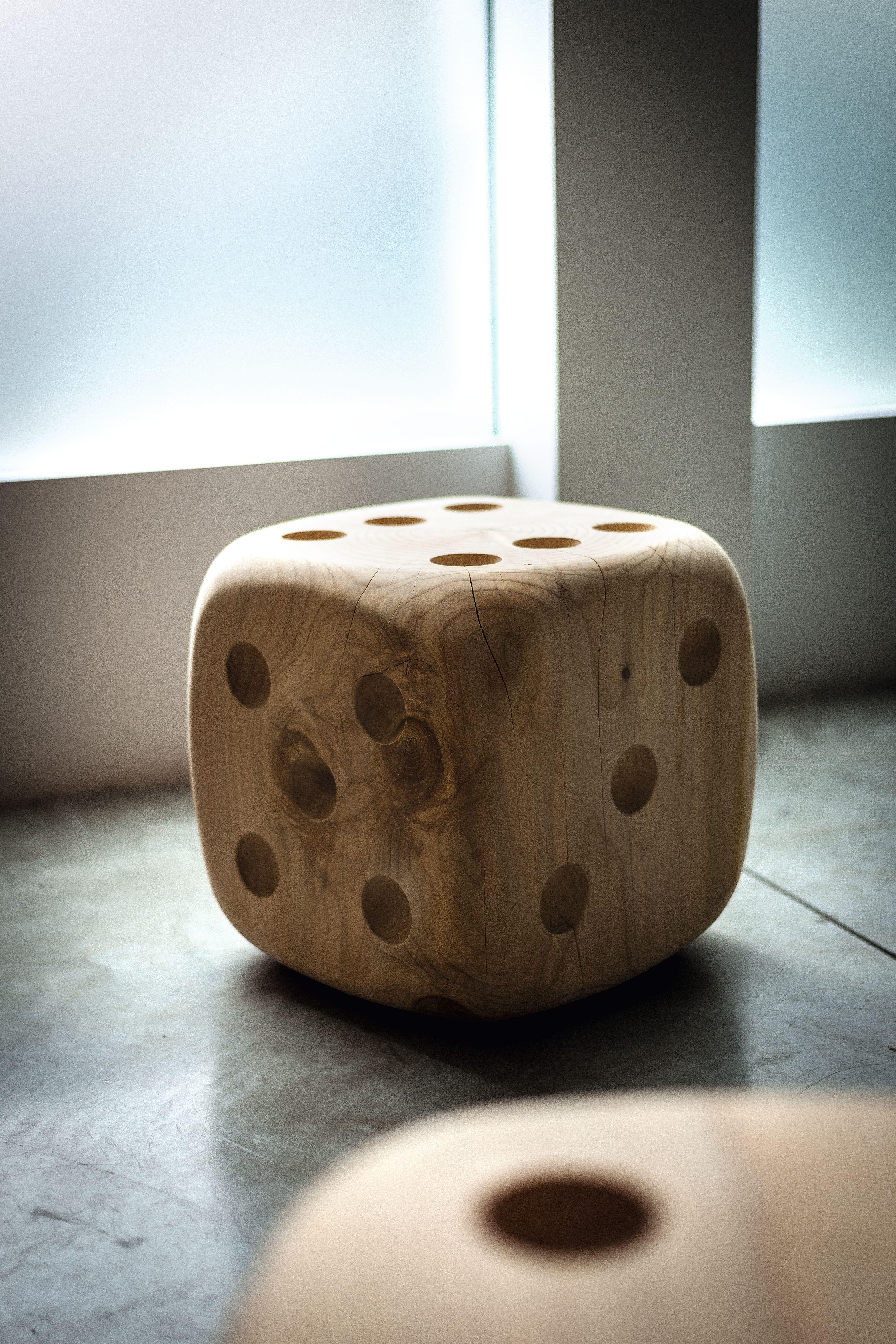 Stool made of a single block of scented cedar wood with clear references to the famous dice game.