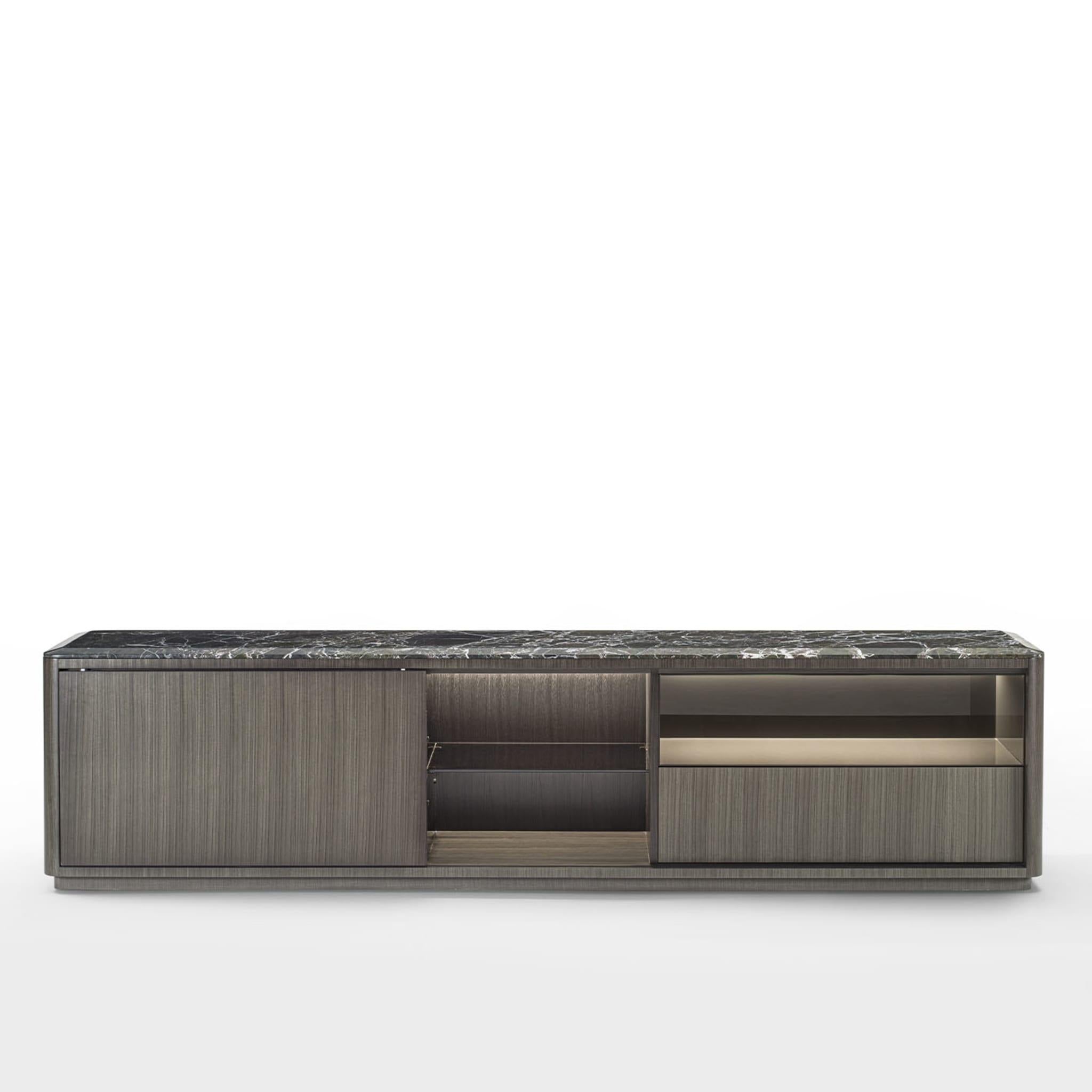 Sideboard characterized by a linear design, embellished by the structure covered in dark Tay and by the detail of the rounded corners. The sliding door creates multiple compositions with open compartments and drawers. The internal structure of the