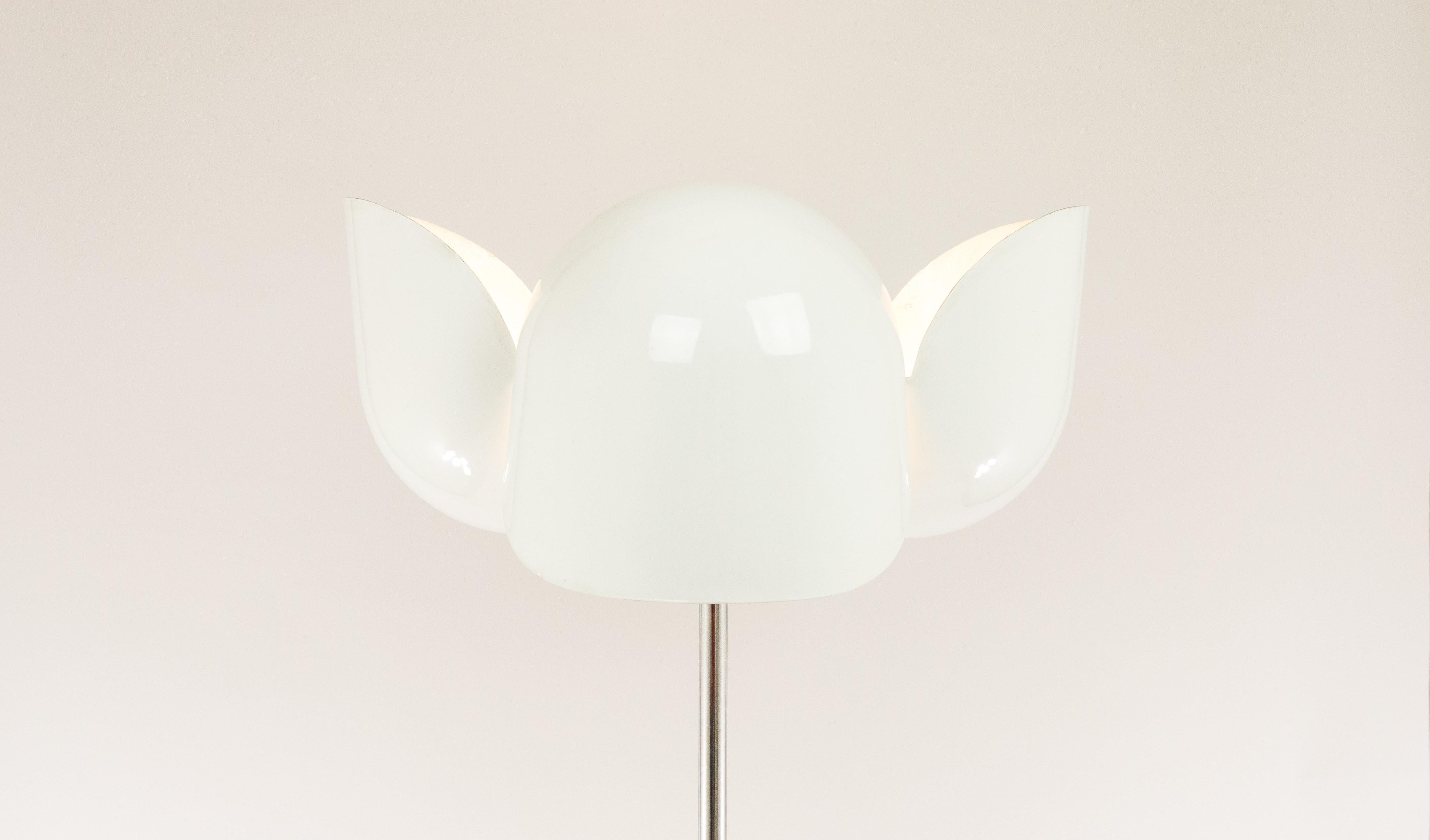 Astonishing floor lamp Dafne designed by Olaf von Bohr for Italian manufacturer Valenti.

The shade from the lamp is made of fiberglass; it consists of two parts which together form the shape of a flower. The on/off switch has two positions, which