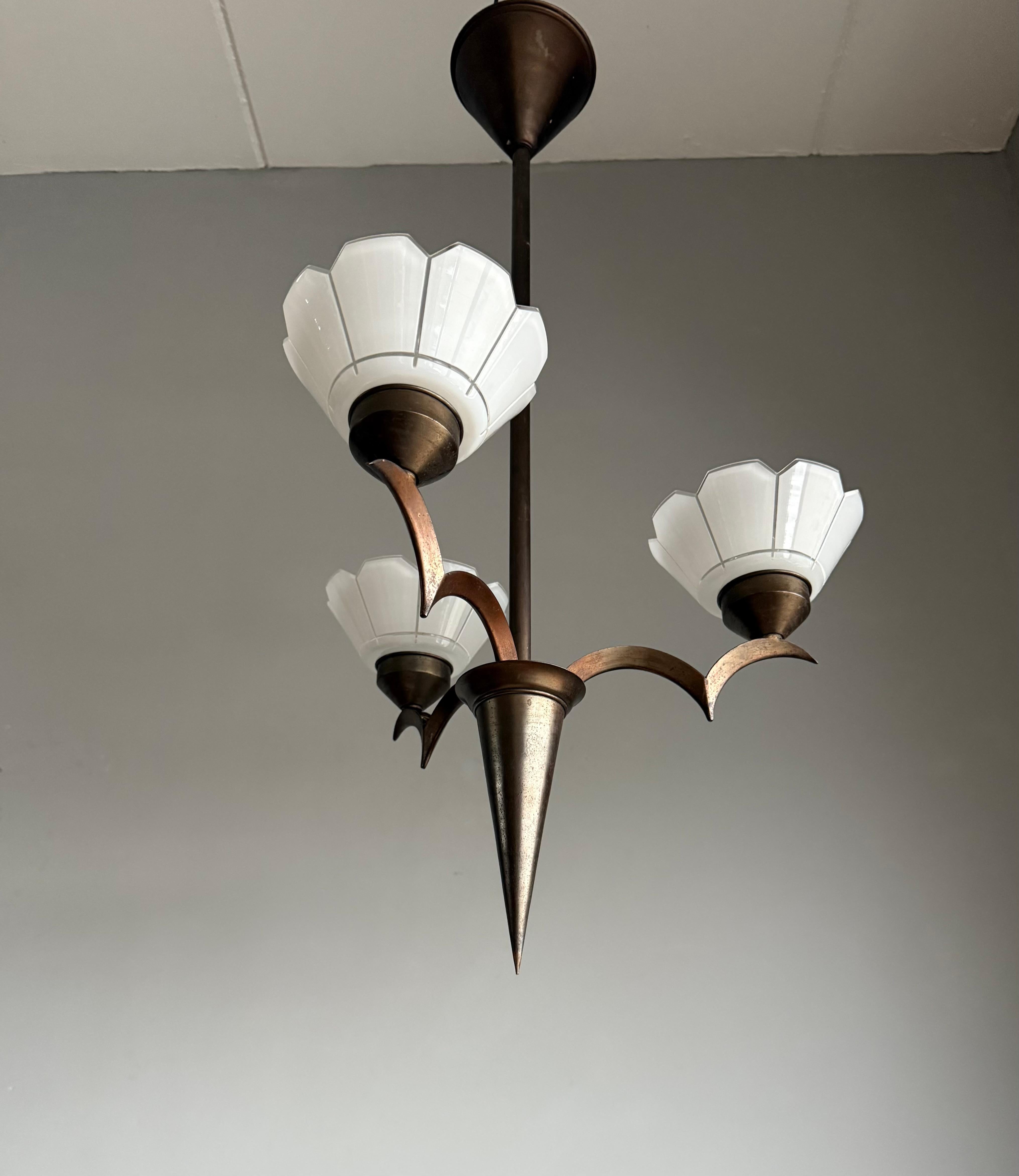 Striking Art Deco brass pendant light with flowery cut glass shades, Dagobert Peche Era.

This unique and practical size Art Deco chandelier stands out for several reasons:

Firstly, it has a stunning stylish brass 'body' which is in excellent