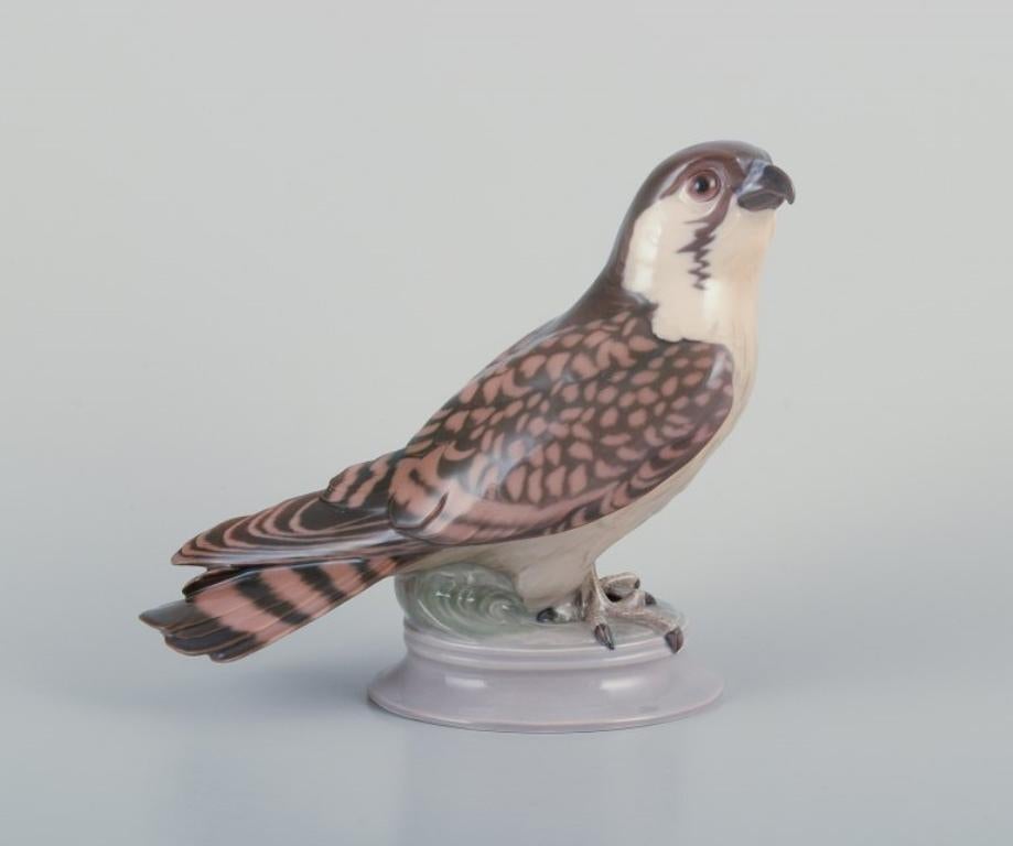 Dahl Jensen for Bing & Grøndahl. Porcelain figurine of sitting peregrine falcon For Sale